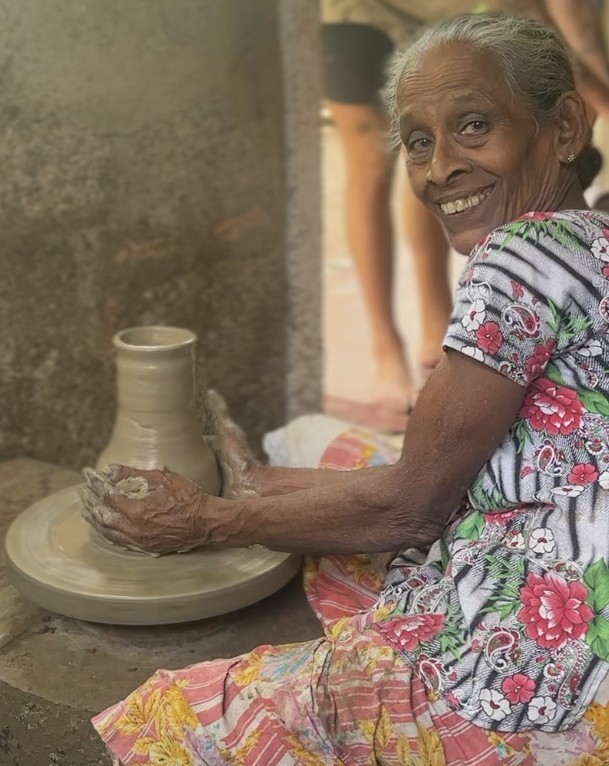 a group of women standing on top of a sandy beach