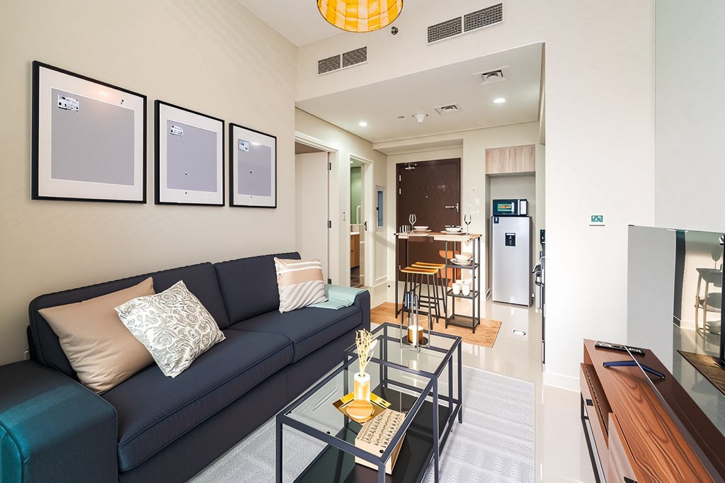 A modern living room with a comfortable couch, a coffee table, and a television, perfect for leisure activities.