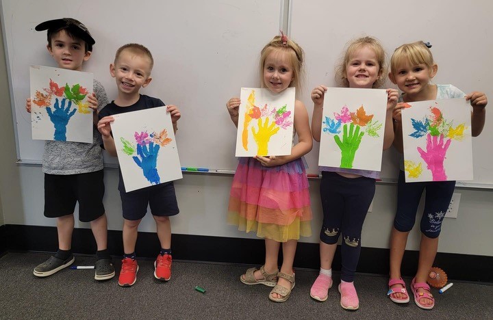 Some of the older preschool kids showing off their art projects