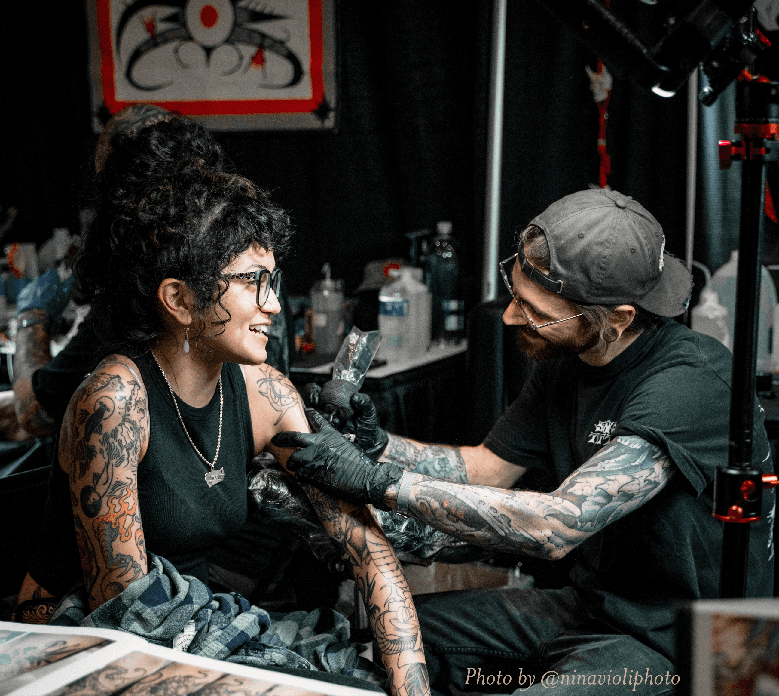 A tattoo artist working on a sleeve at the Richmond Tattoo and Arts Convention.