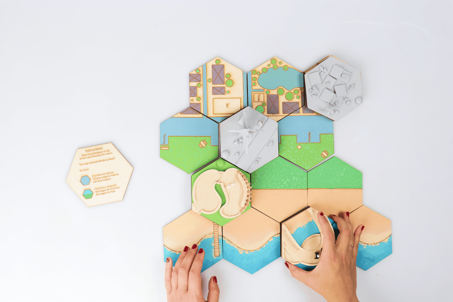 Close-up of hand holding pink ice cream cone against pastel background