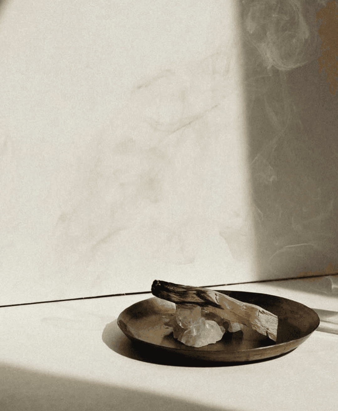 A luxurious indoor pool area with a panoramic view of a city at sunset. Comfortable lounge beds with soft fabrics surround the pool, while warm ambient lighting enhances the sophisticated atmosphere. The space combines modern elegance with a tranquil vibe.