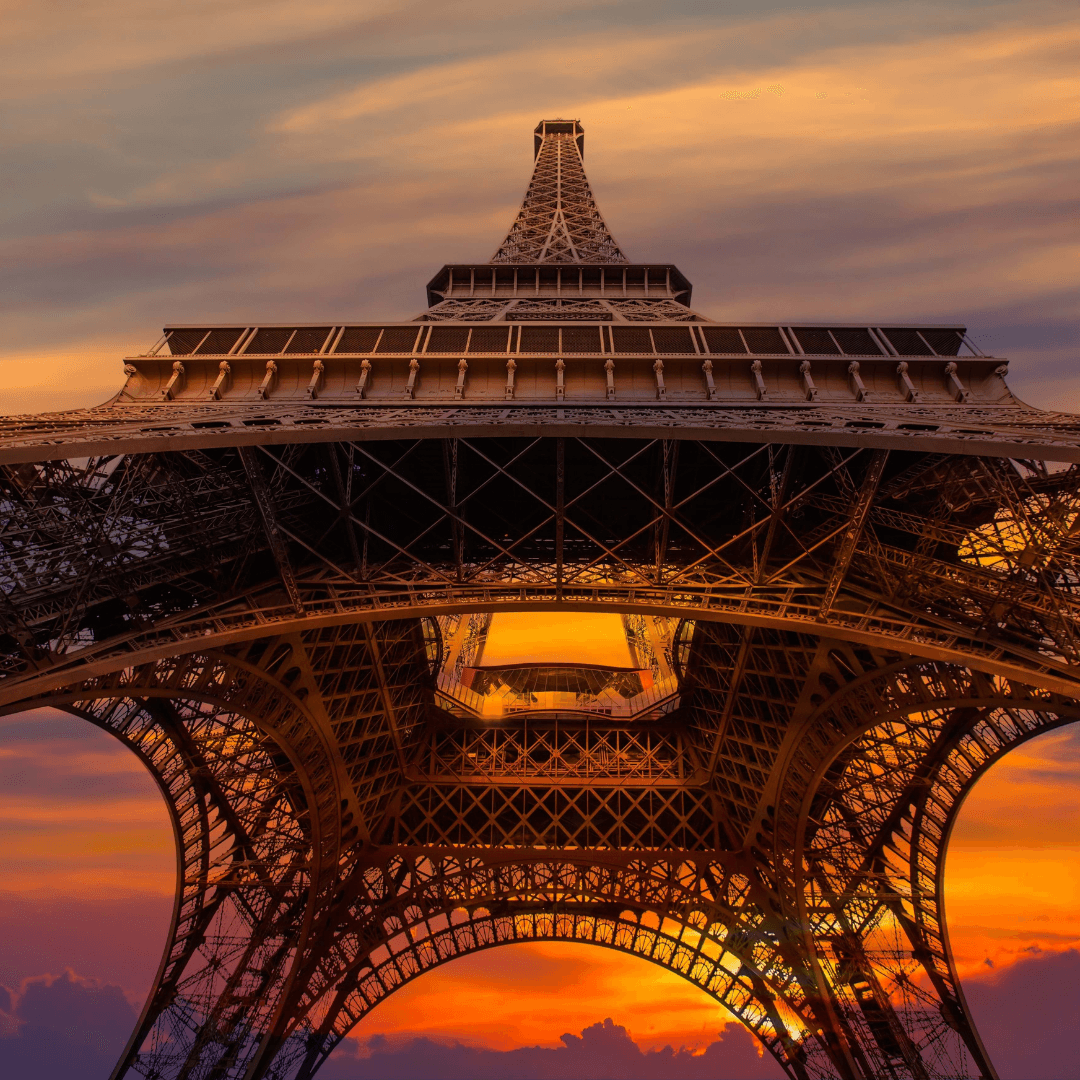 Upward view of the Eiffel tower, Las Vegas during sunset. Book tickets to view Eiffel tower from observation deck, experience the Las Vegas Strip at night with casinos, hotels, and night show.