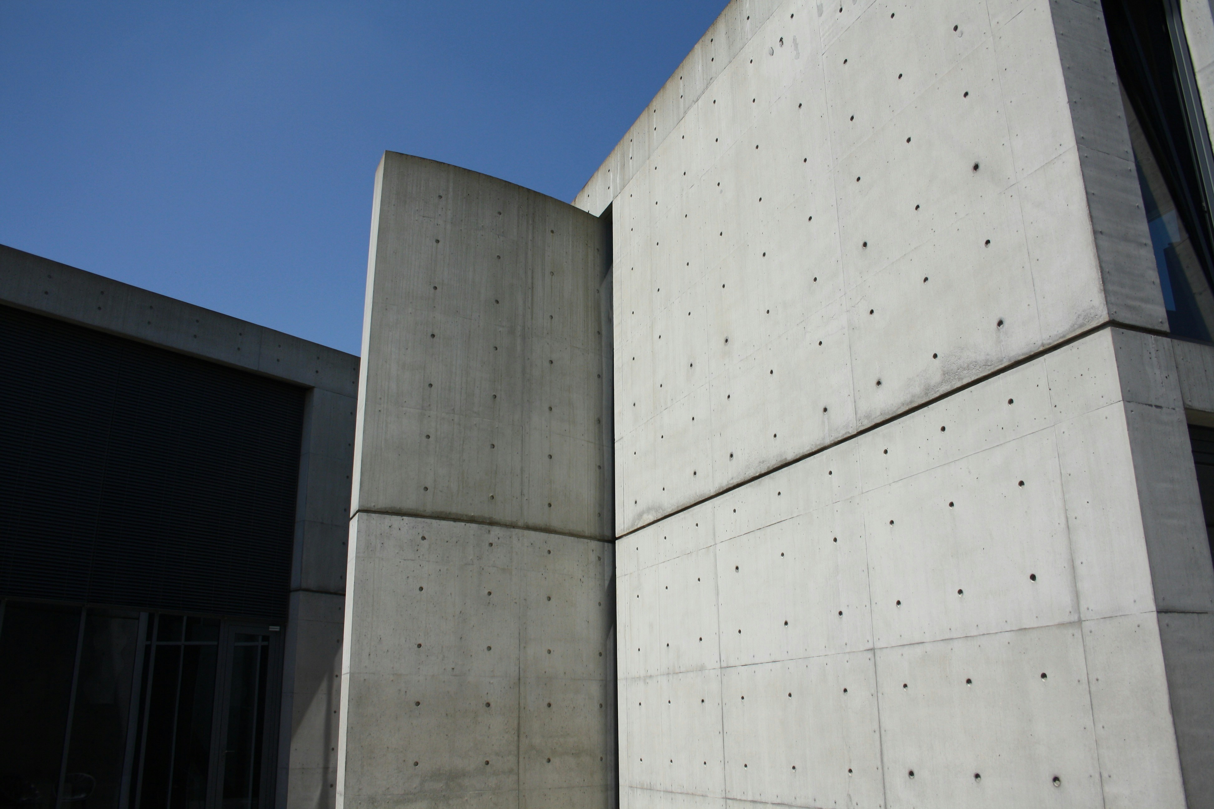 a concrete structure set against a backdrop of clear blue sky