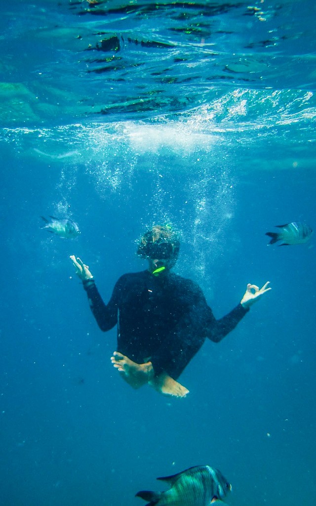 Lukas in a yoga pose under water