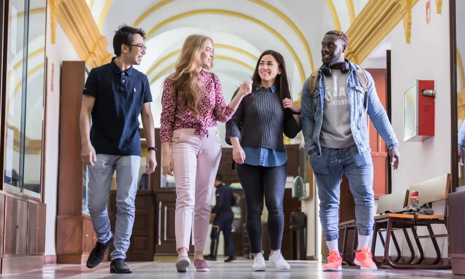 man in academic dress wearing mortar cap