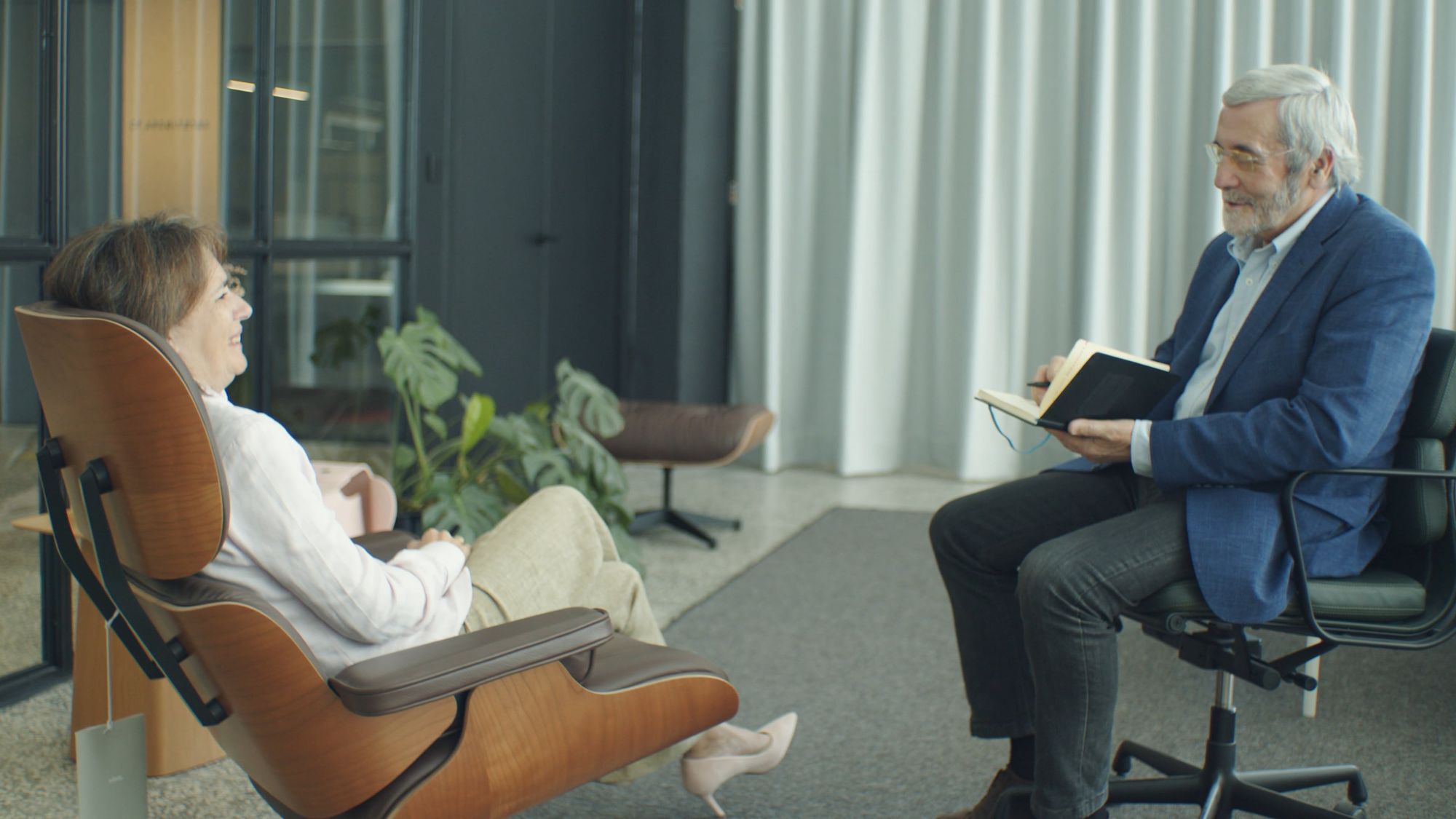 A therapist listening to a client in a bright, calm therapy room