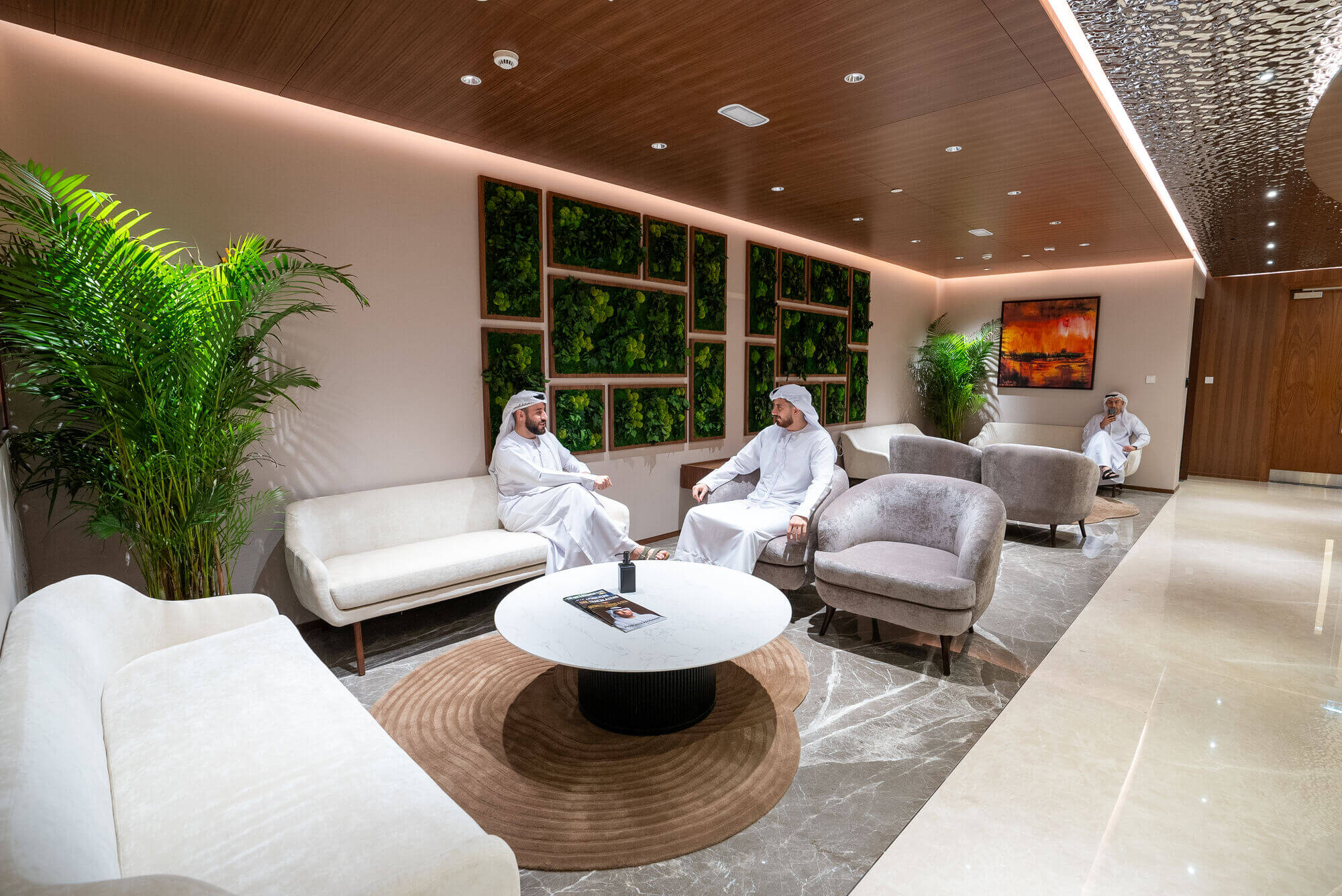 Group discussion in luxury lounge highlighting premium pro services Abu Dhabi in a high-end business environment.
