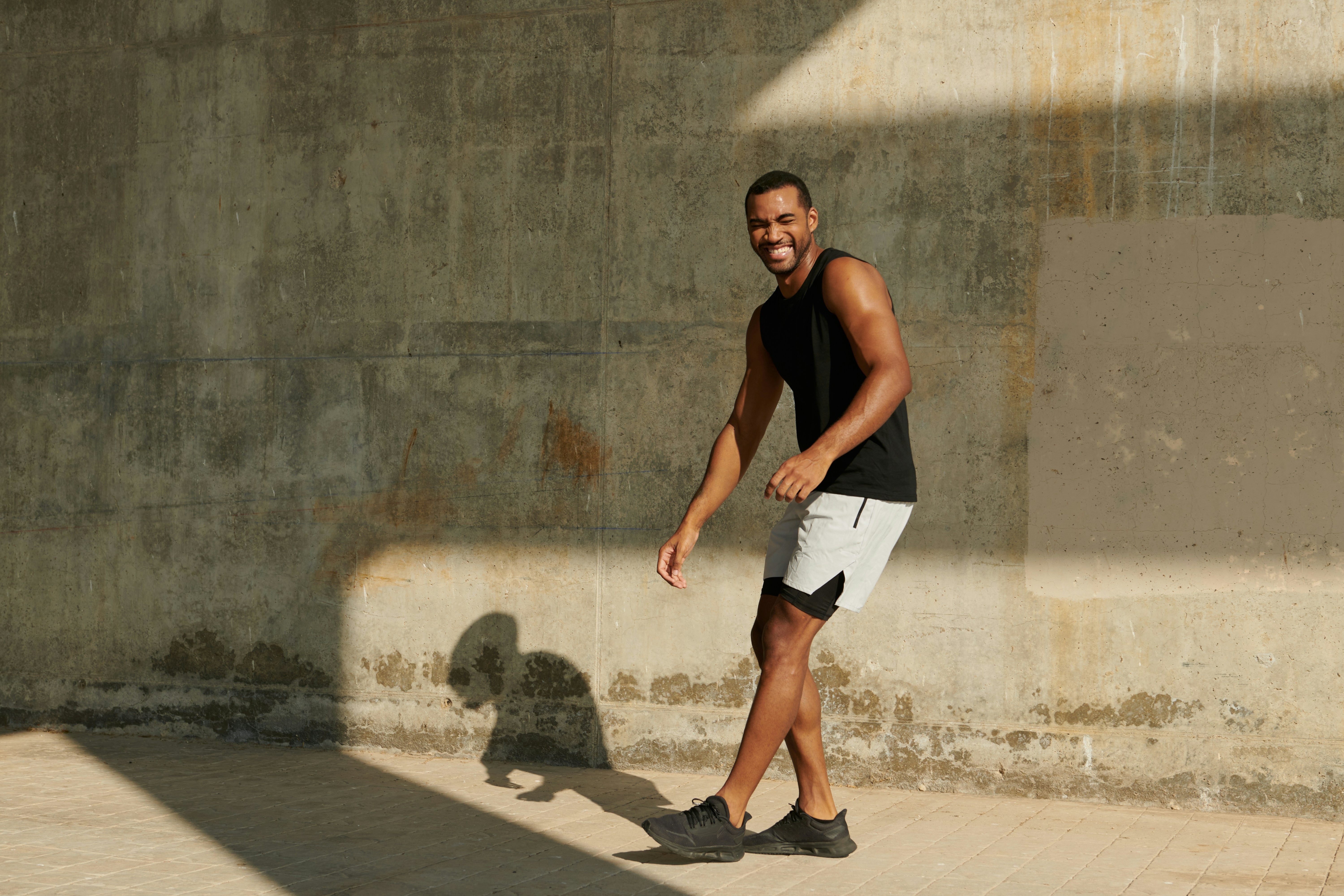 man in black tank top wearing black headphones