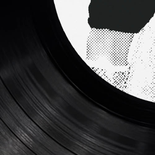 Close-up of a black vinyl record with a white label.