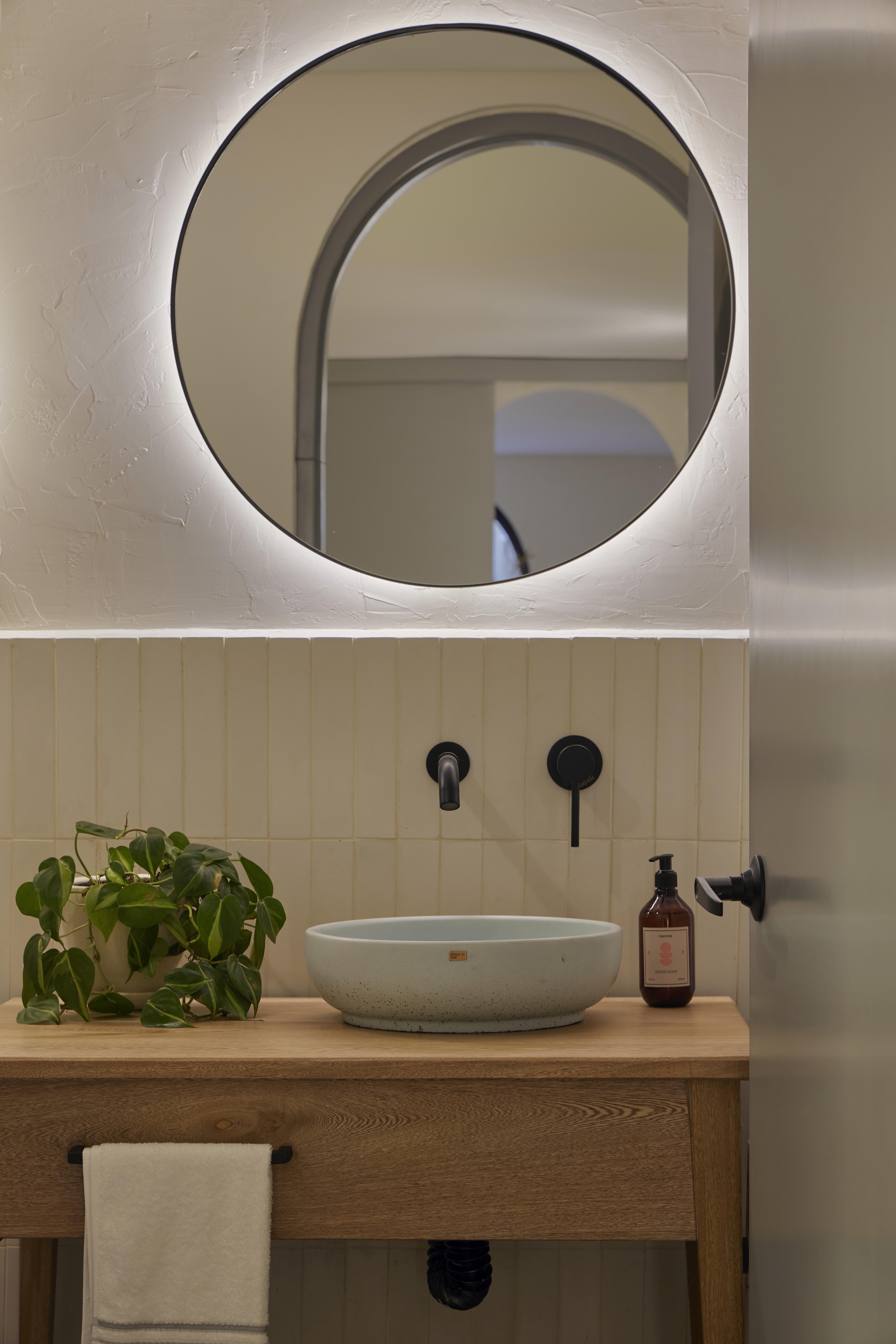 Double-height interior with flowing sculptural forms and warm raking light