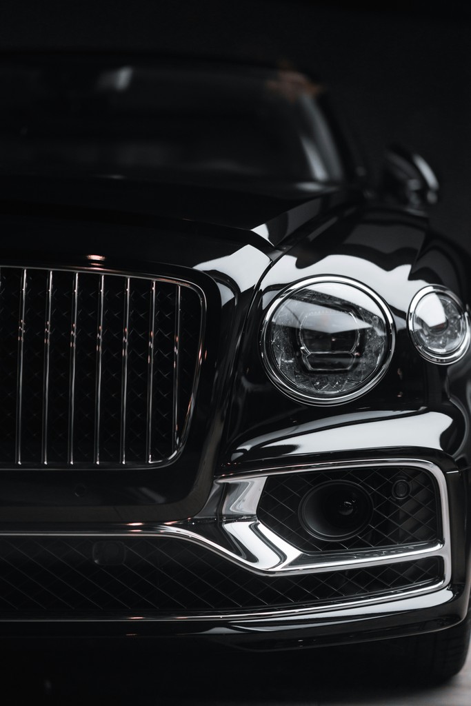 silver car headlight in grayscale photography