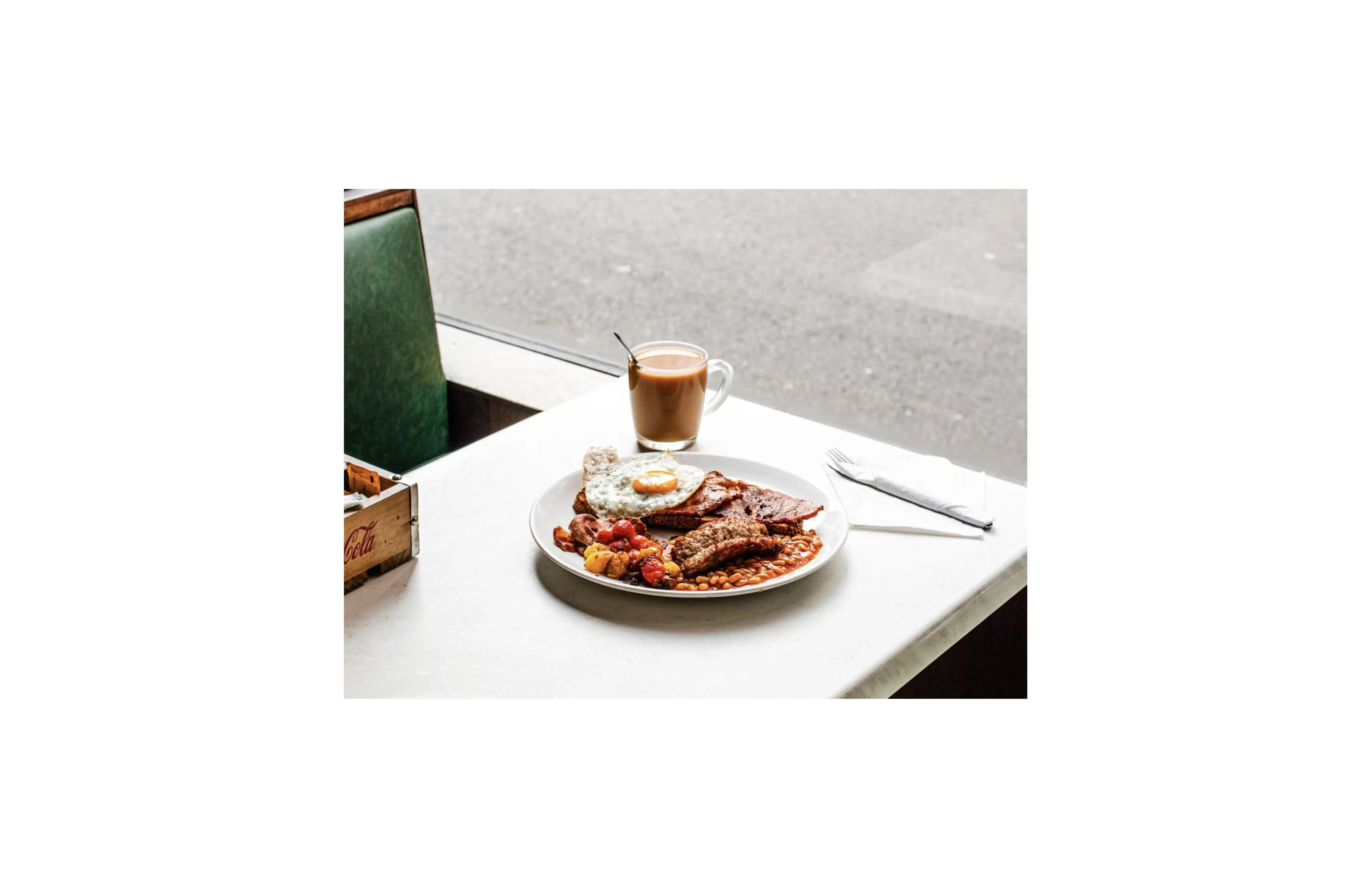 A full English breakfast with eggs, bacon, toast, baked beans and coffee, illustrating how the same meal can be measured in both dollars and satoshis to compare Bitcoin purchasing power over time.