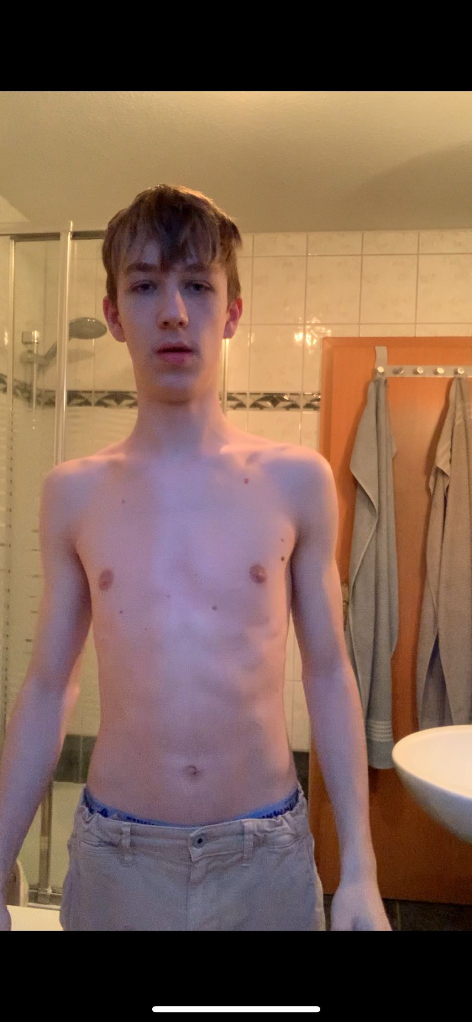 man in white crew neck t-shirt and black shorts sitting on floor