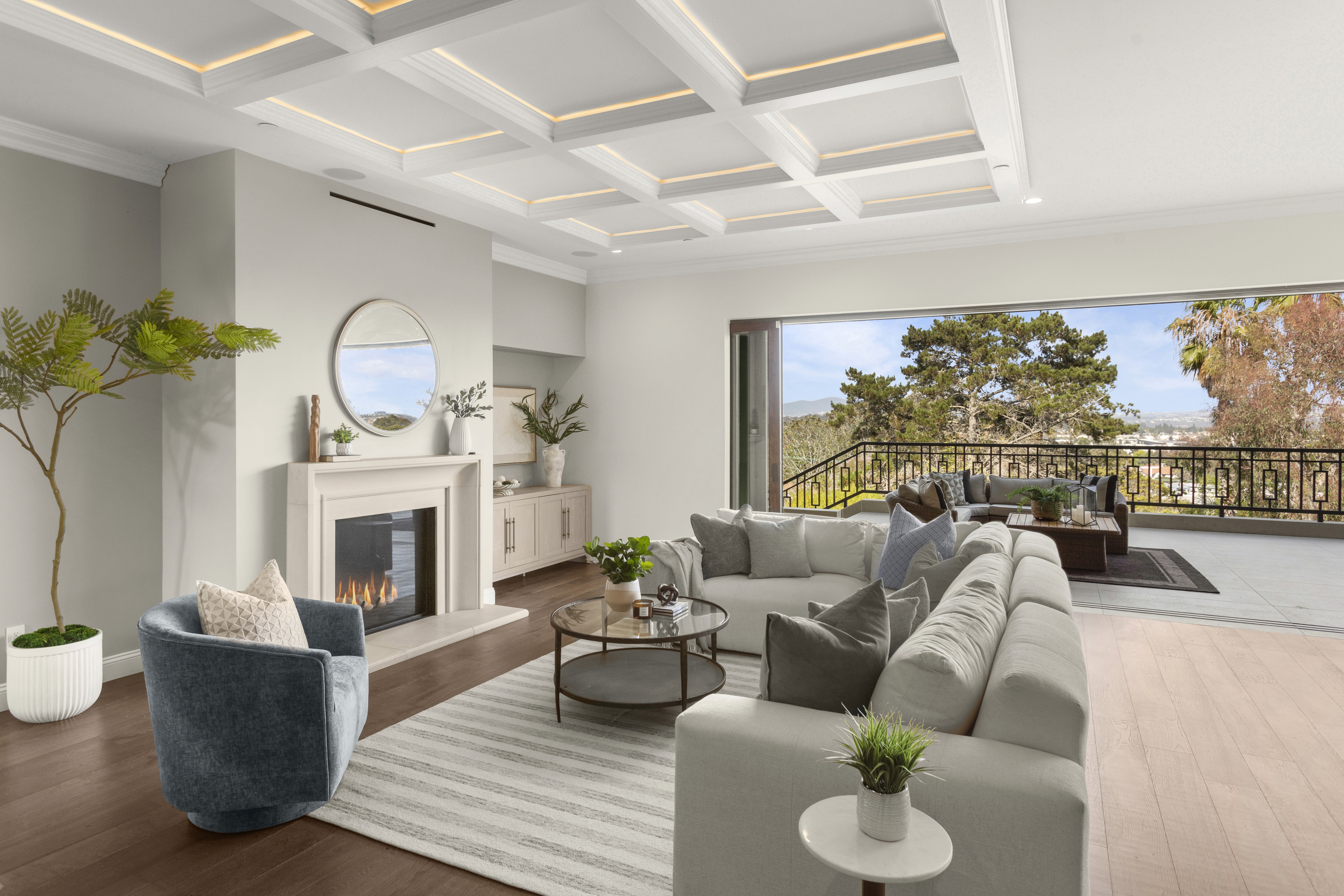 Professionally staged living room with a fireplace and view balcony