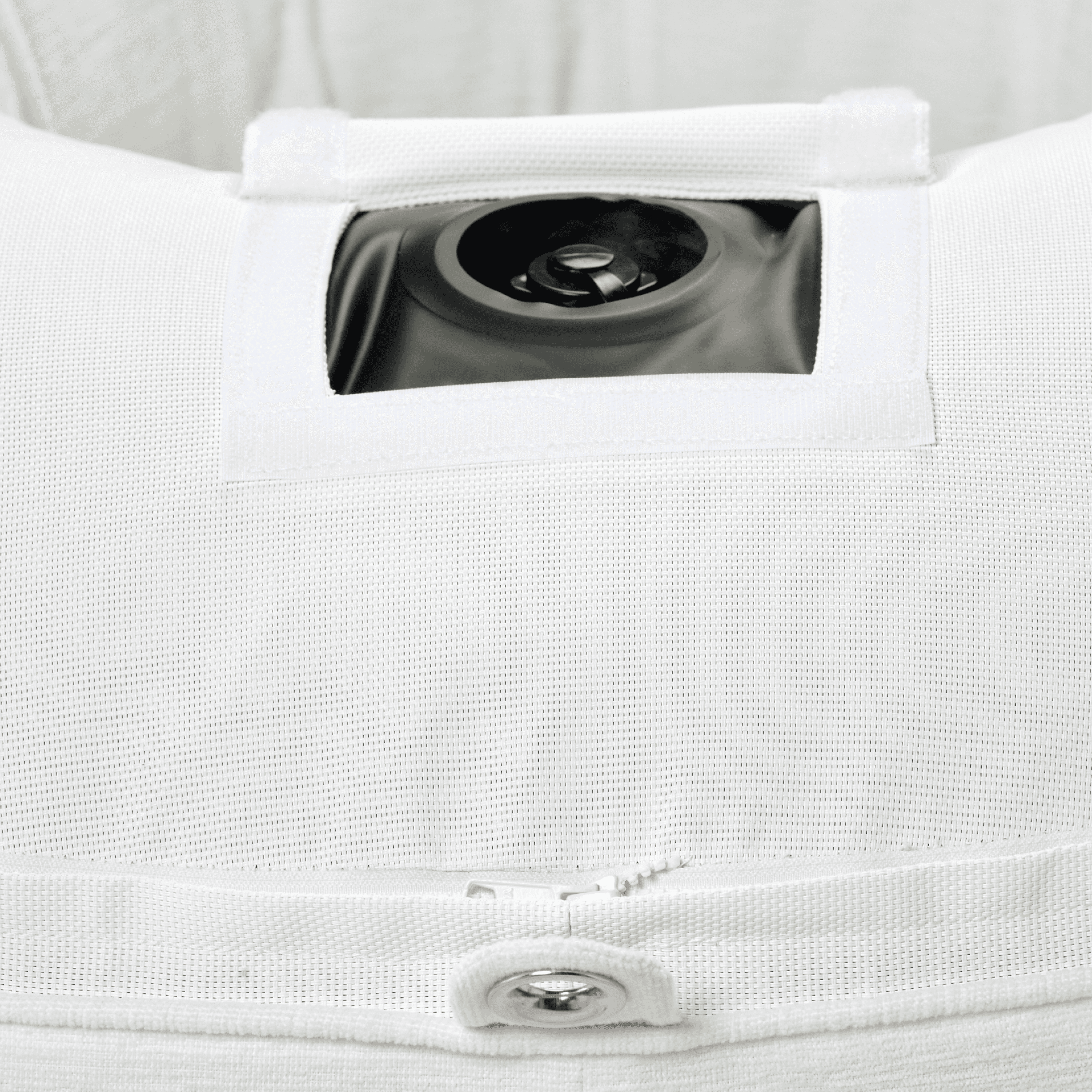 Close-up of ring pool float showing white chenille weave, inflation valve, and stainless eyelet