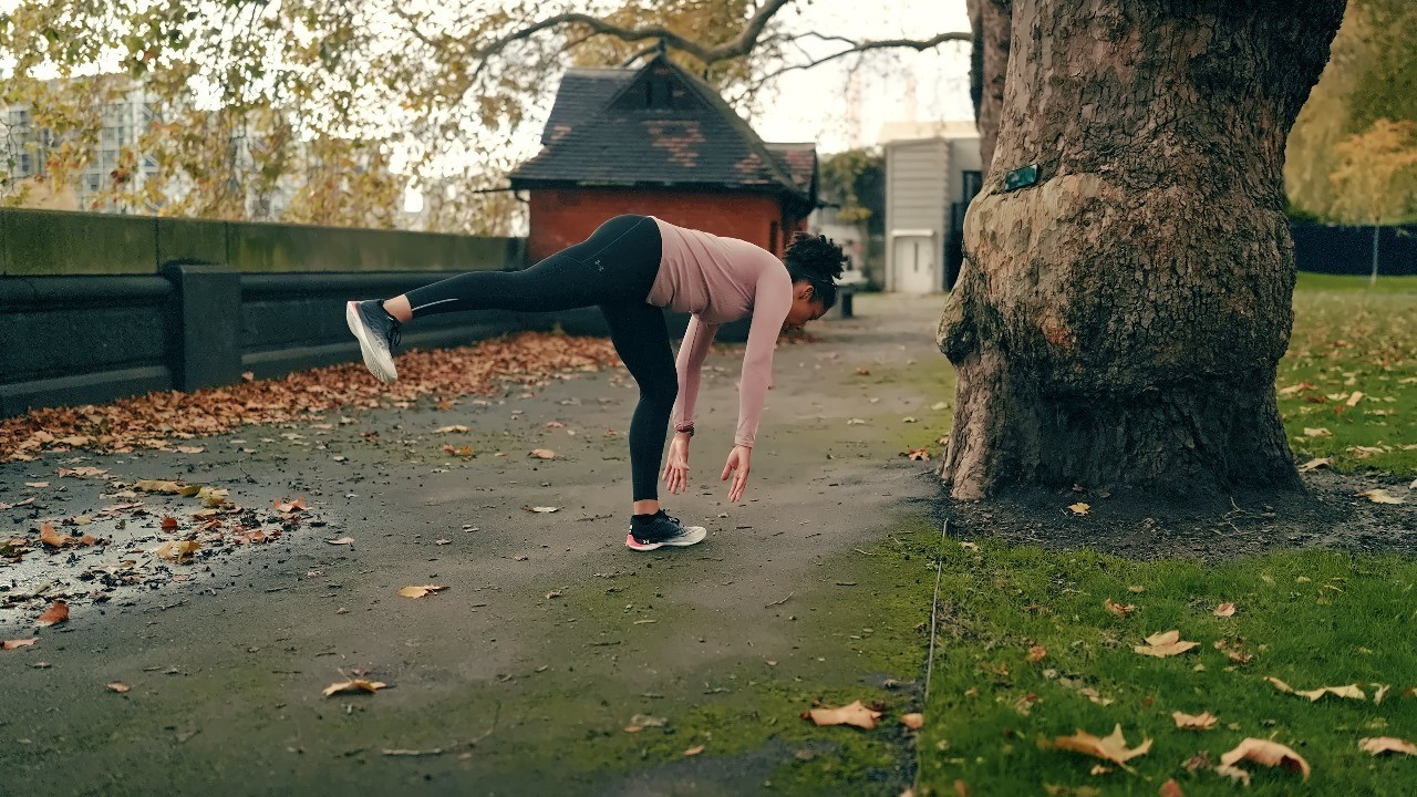 Person at backyard of her home - Hamstring Stetches