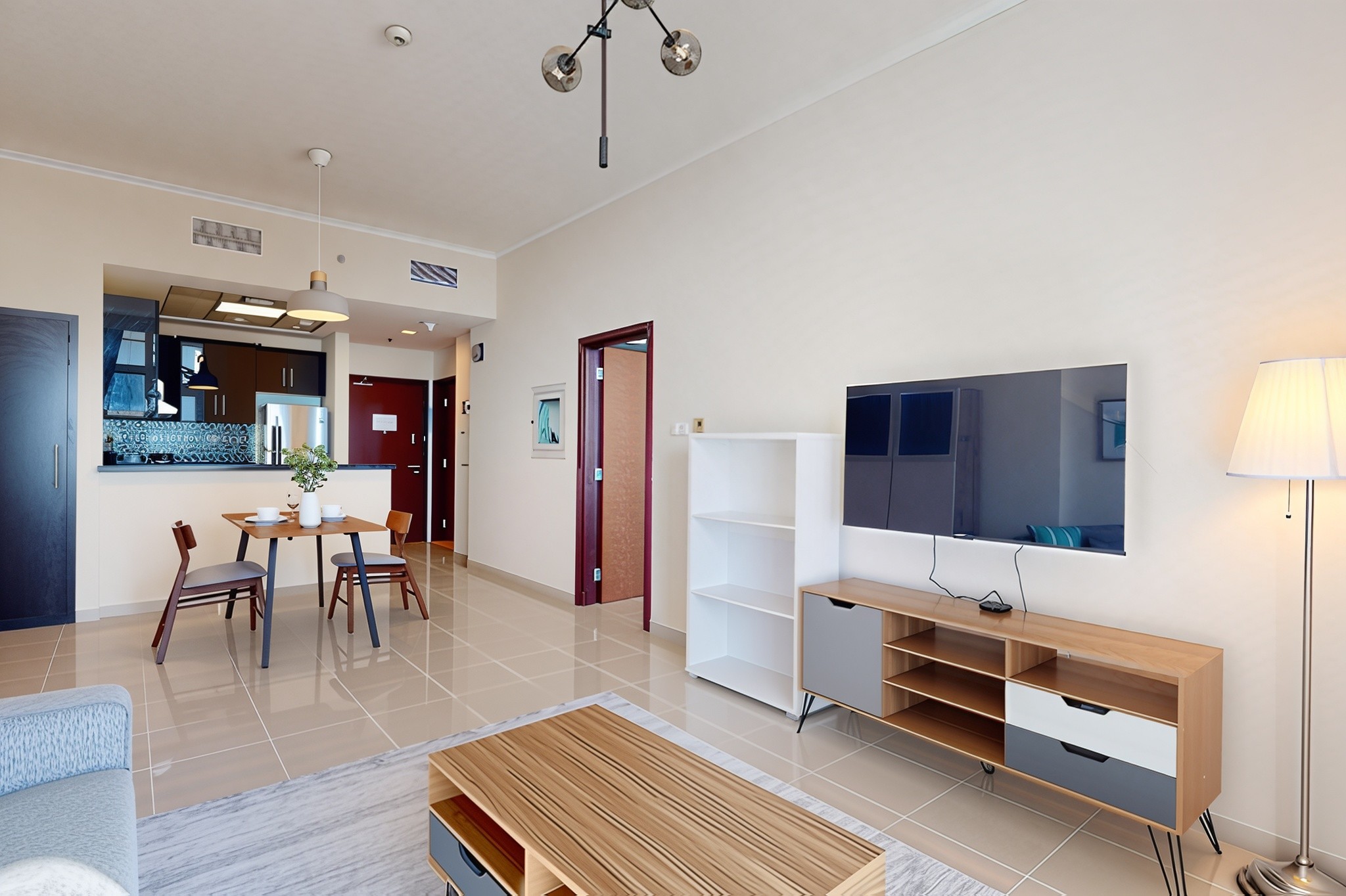 Bright living room and kitchen space in a modern apartment at Botanica Tower, featuring elegant furnishings and design.