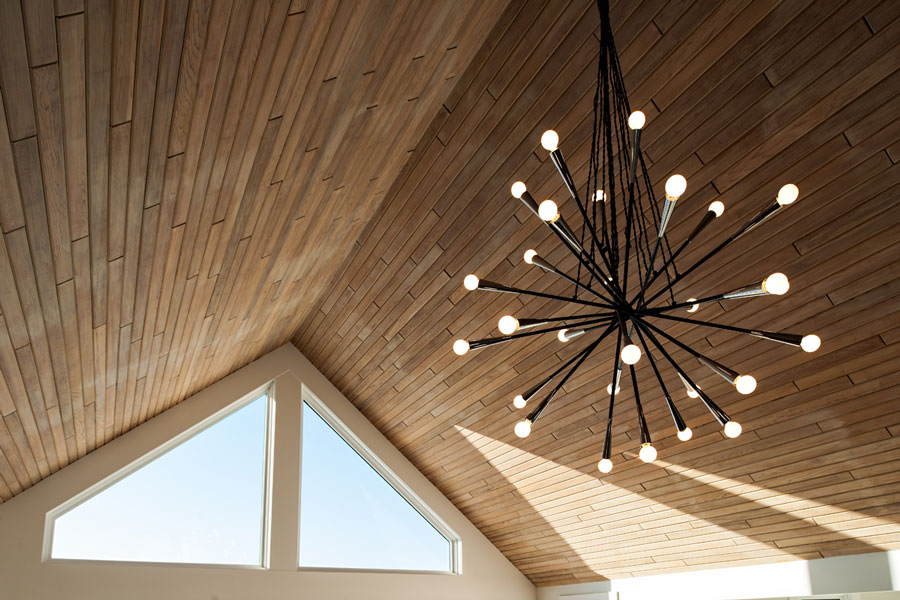 Image of Modern light fixture installed in a luxurious room designed by KHD Homes with interior design expertise.