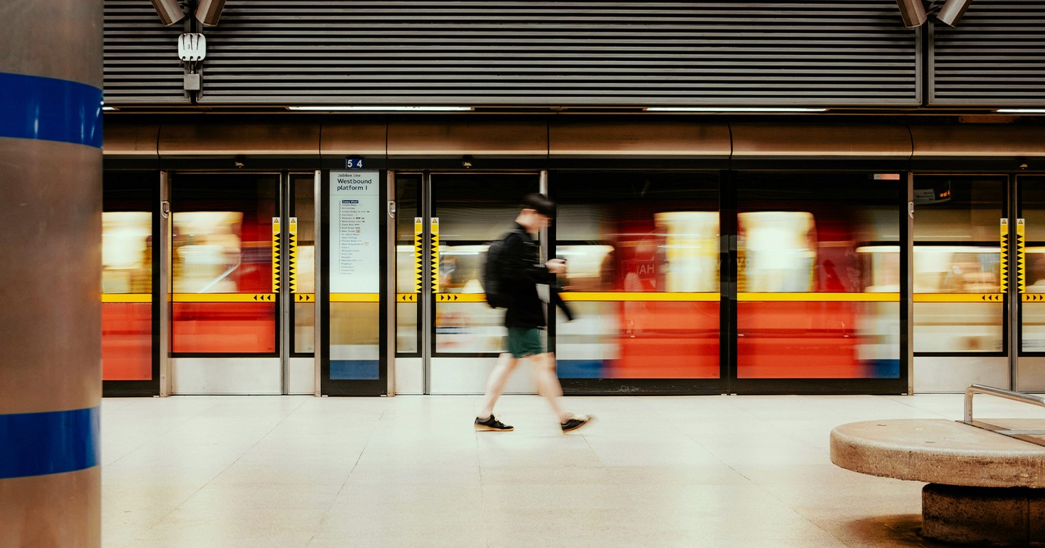 Man walking past busy train