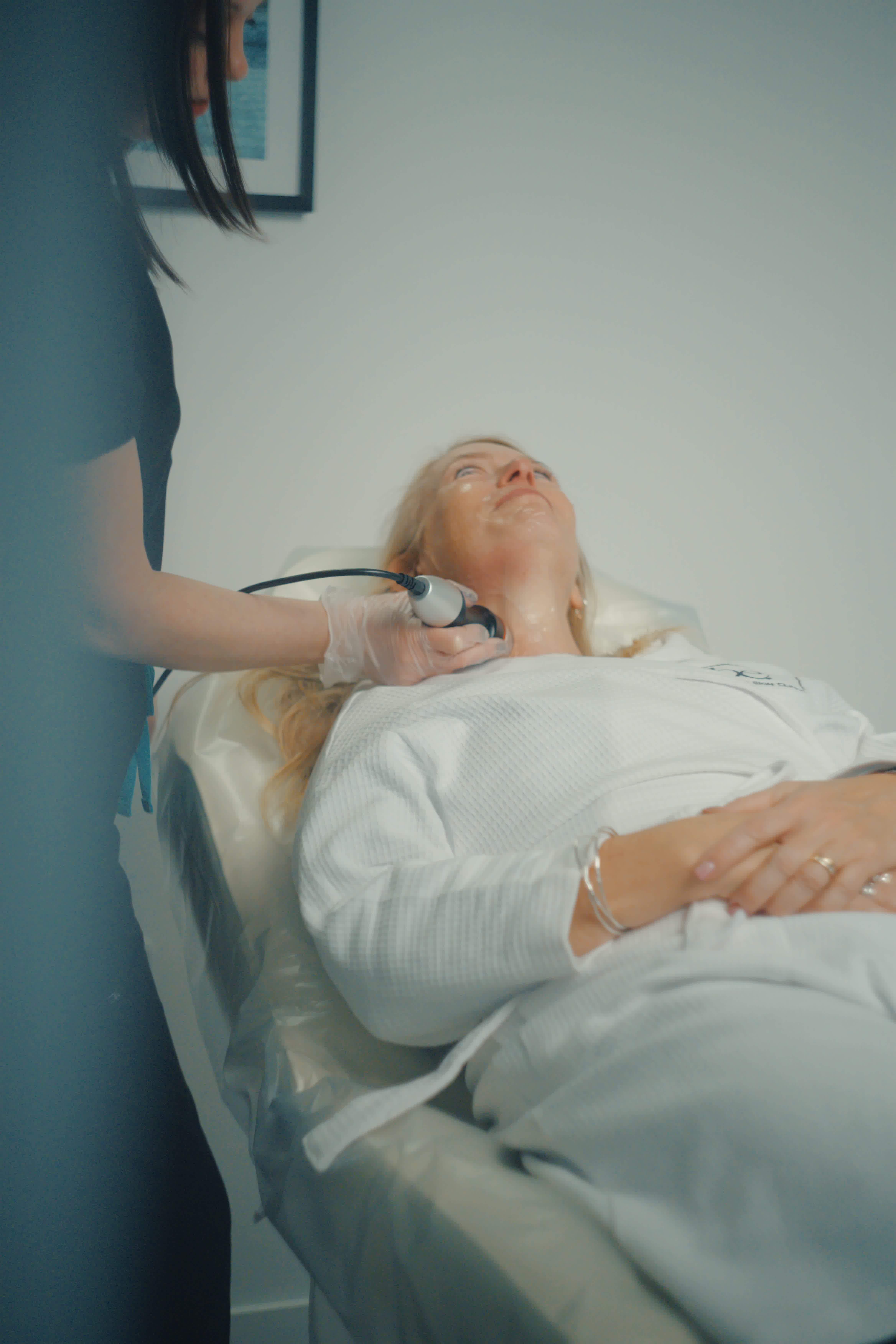 Laser treatment on woman's cheek with protective eye shield