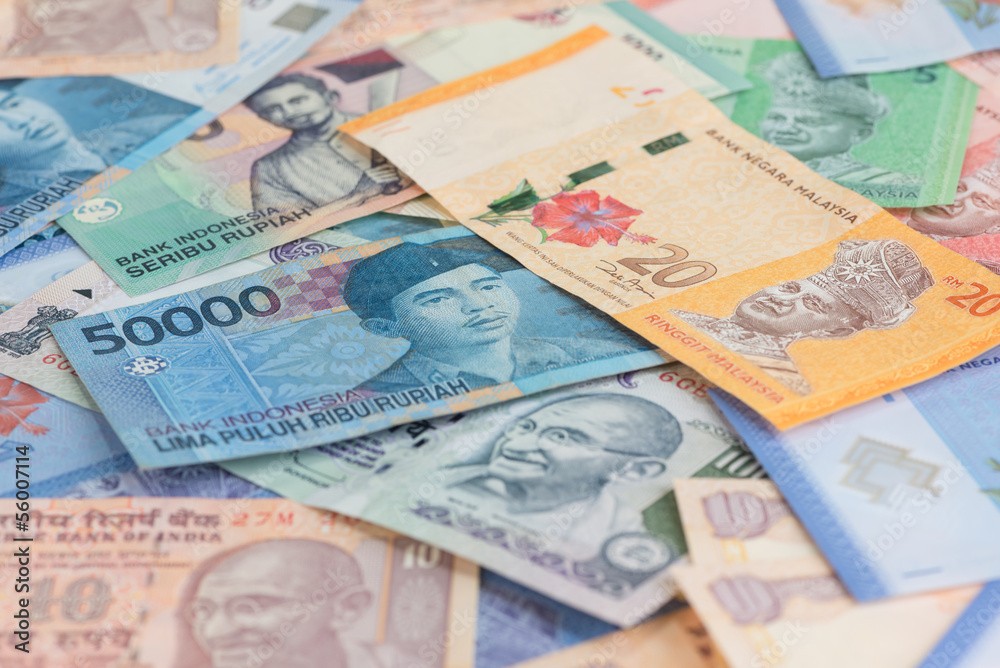 Banknotes from multiple international currencies used for currency exchange.