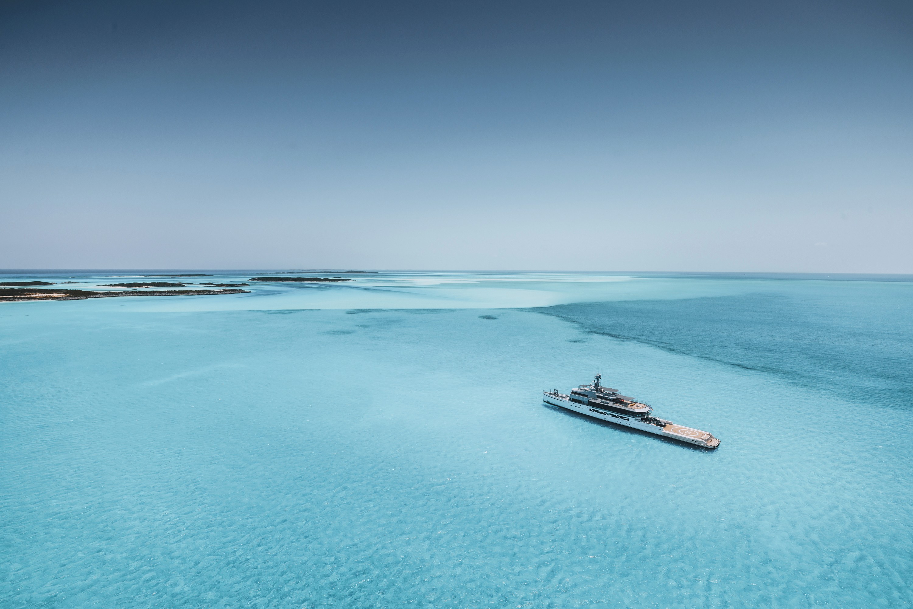 Cozy orange velvet lounge chair by glowing lamp.