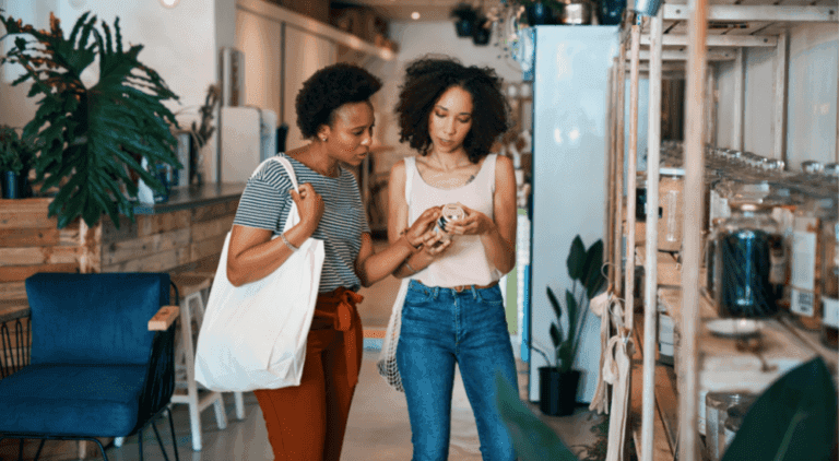 Two shoppers examining a product, representing the impact of price elasticity on consumer behavior
