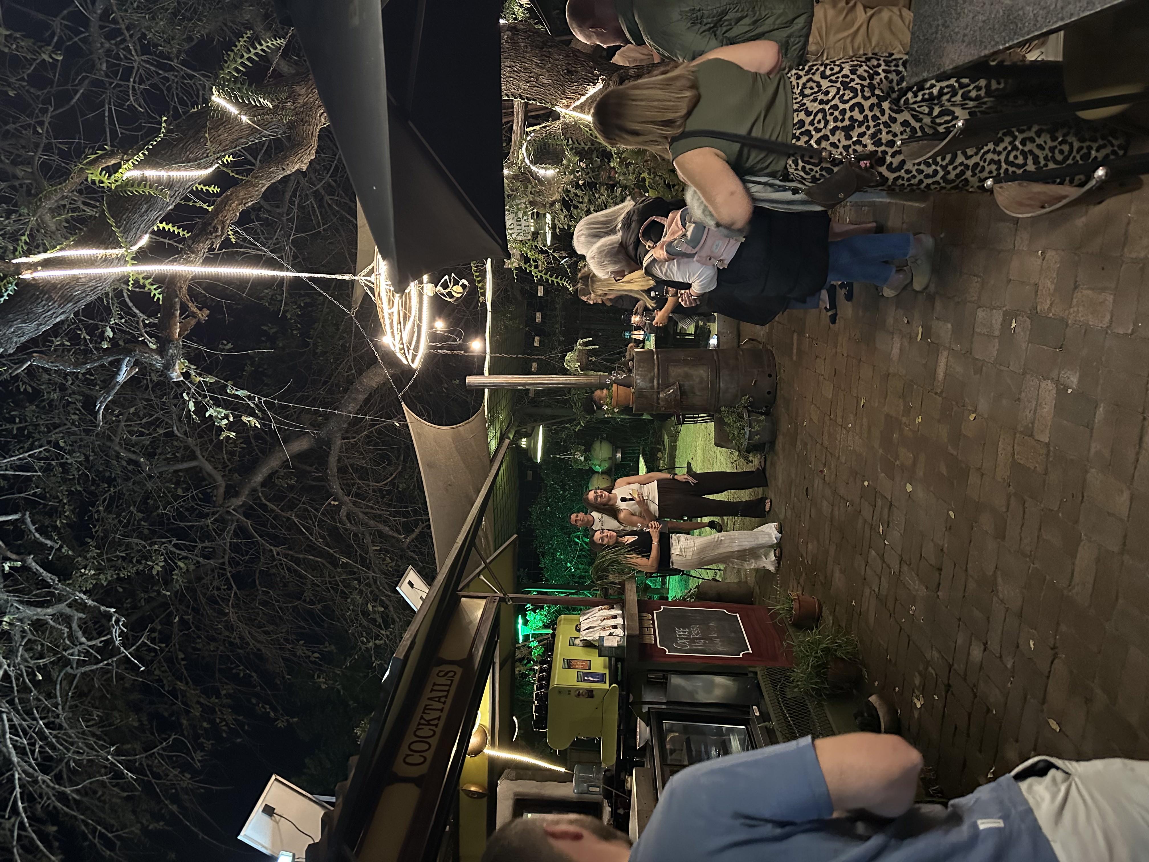 Olivia bedford and Victoria Bakos, co-founders, talking at an outdoor event in Hoedspruit with a small group of travel operators listening