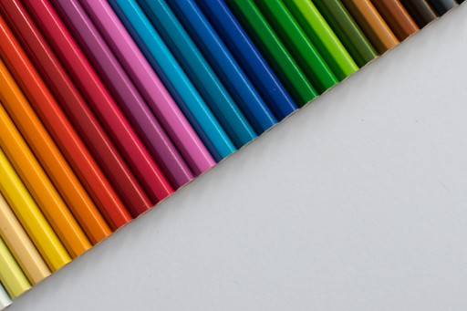 A row of colored pencils sitting next to each other