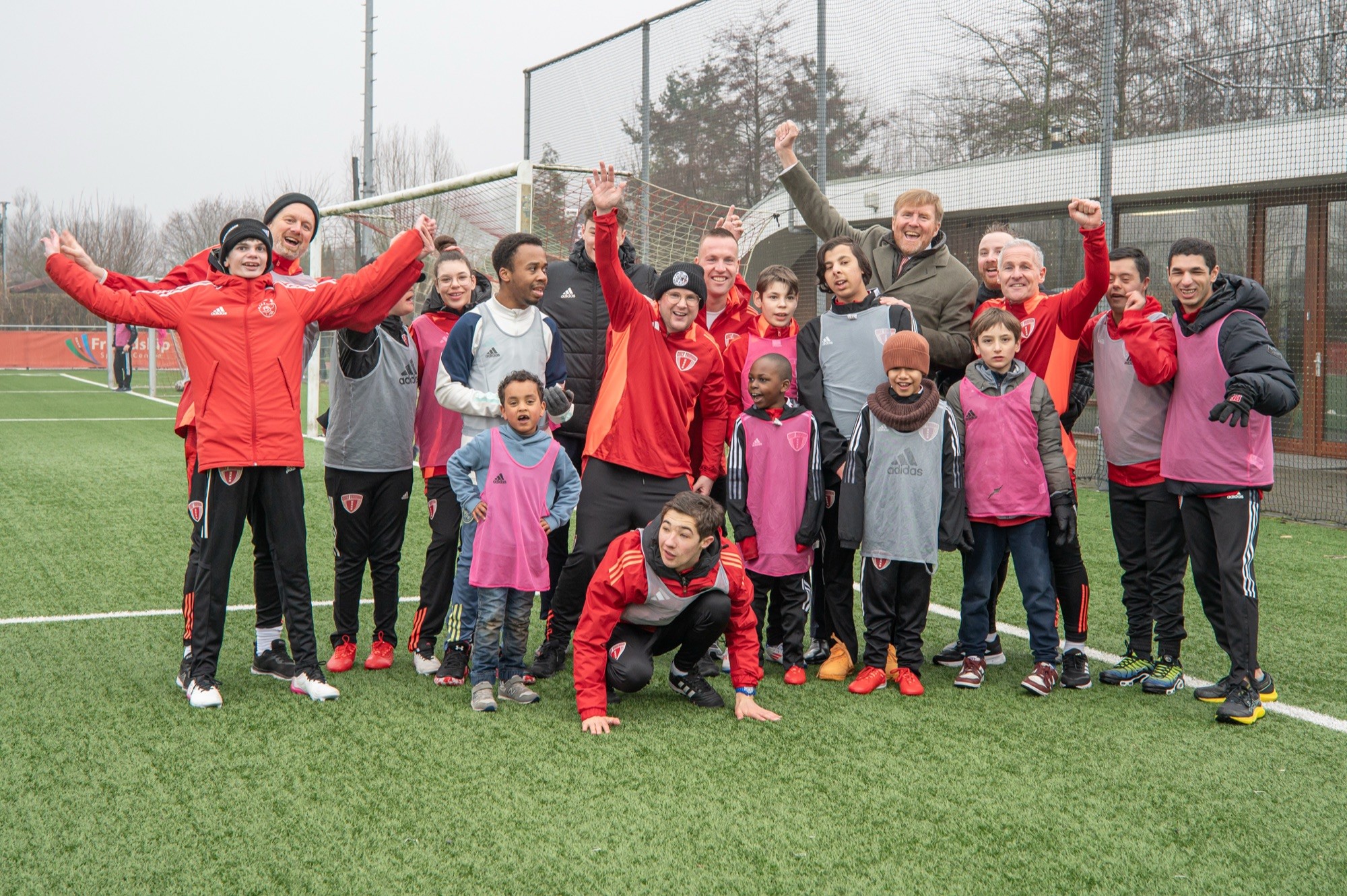 The King with players and coaches of Only Friends on the pitch