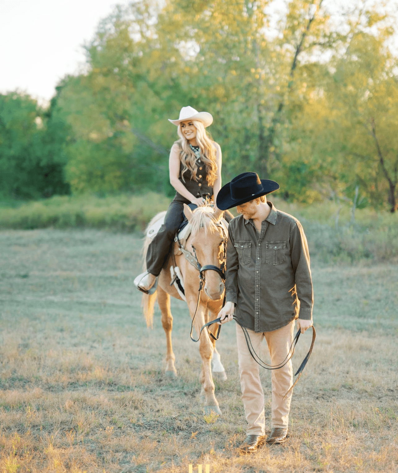 Couple portrait with dog on field