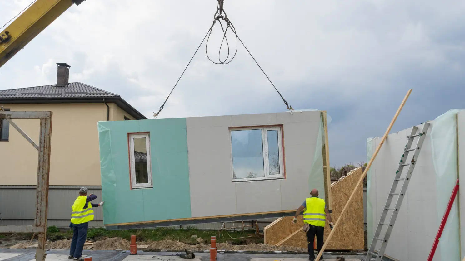 Men working with offsite construction project, image