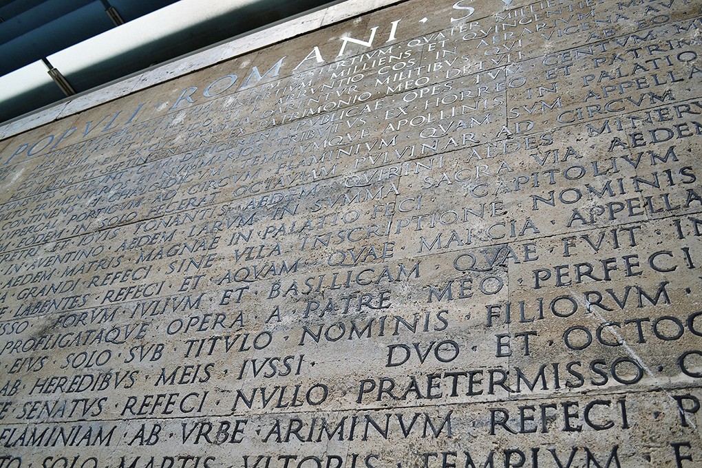a wall with engraved text on it