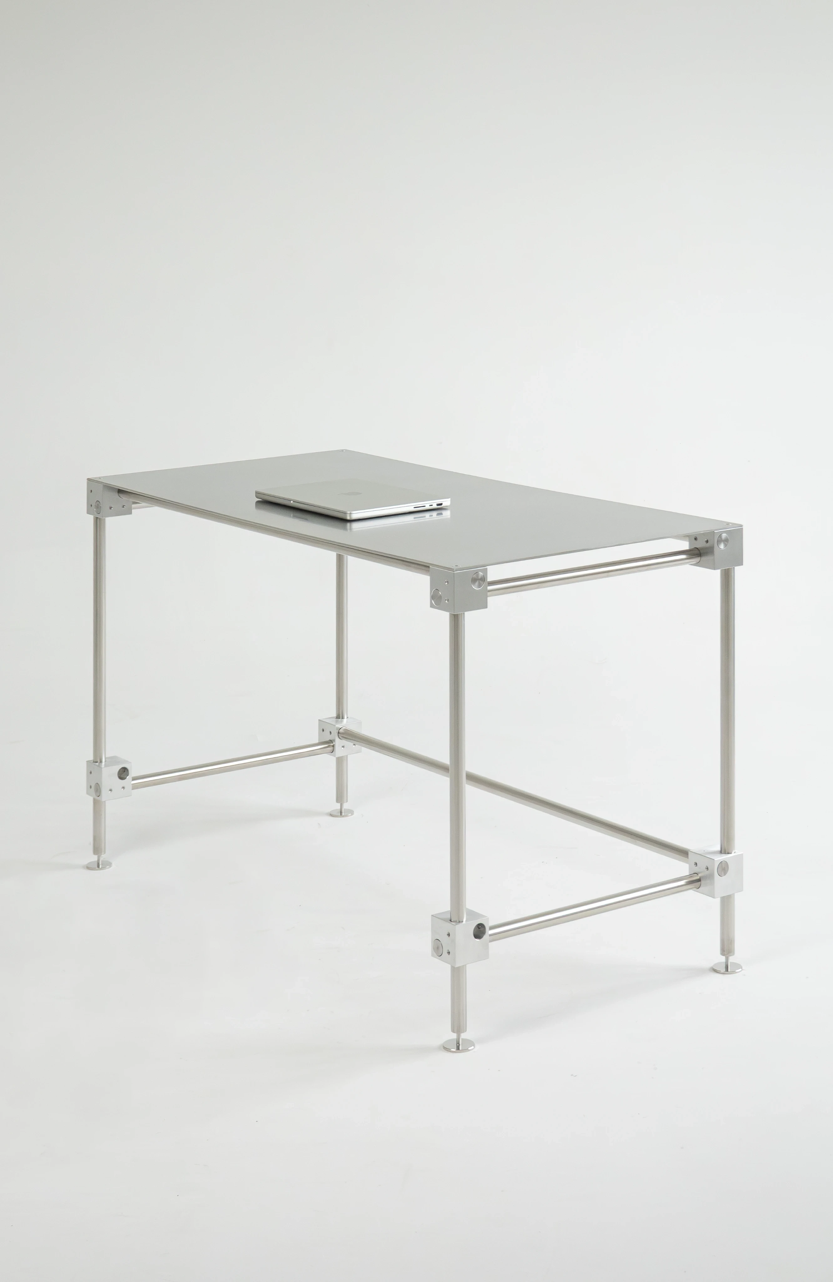 Jan Gliński AXI3 XL office desk, modular stainless steel pipe frame under a flat top