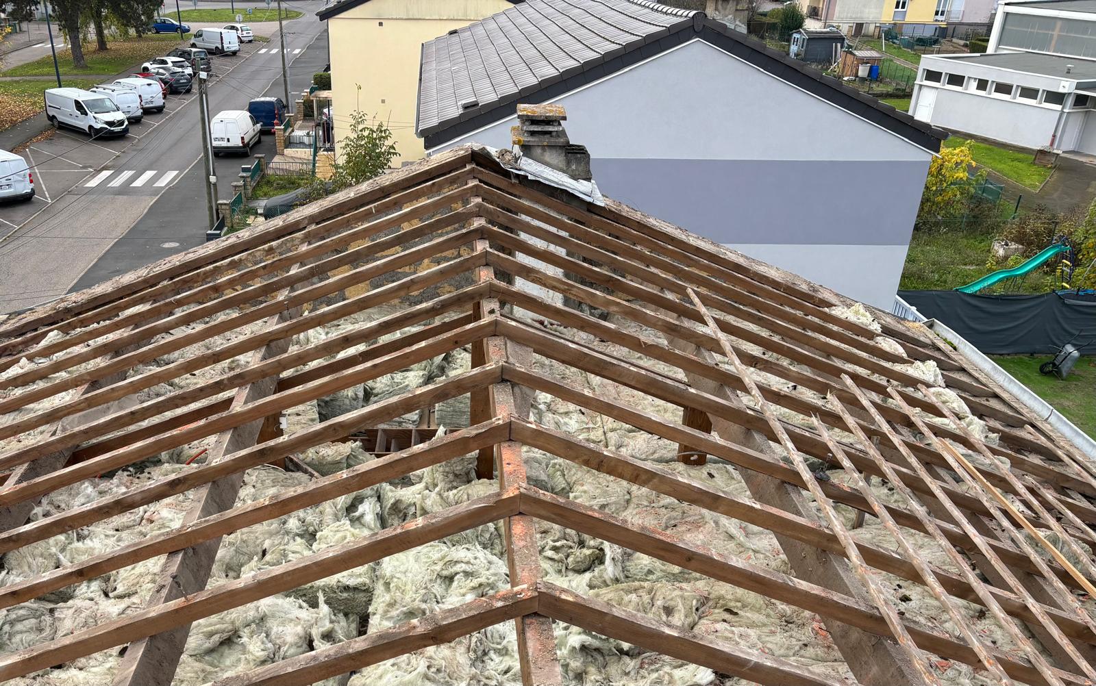 Couvreur expert réparant une toiture après orage violent à Metz