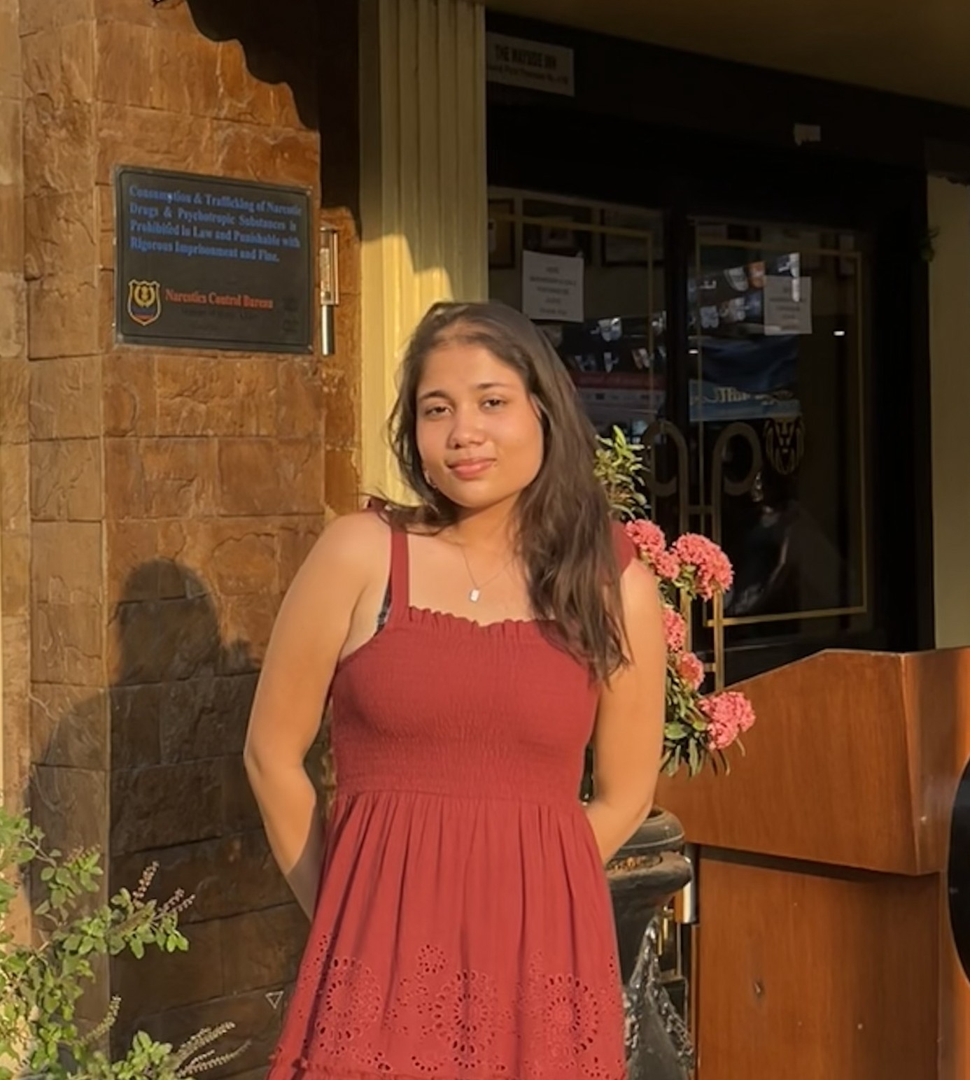 A woman with red hair is standing in the grass