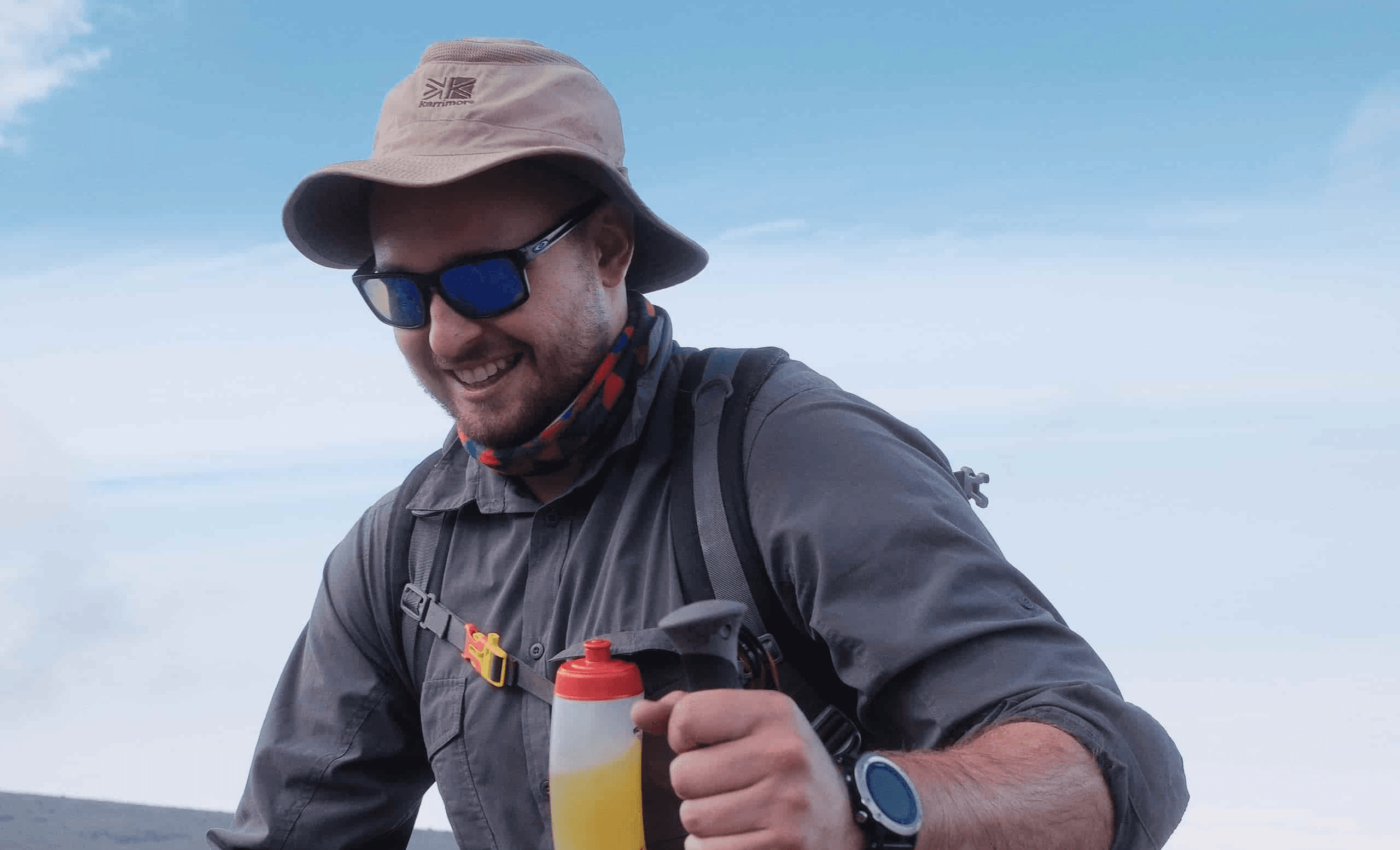 A Legend climber walking pole pole on Kilimanjaro at a steady, measured pace on the mountain trail.