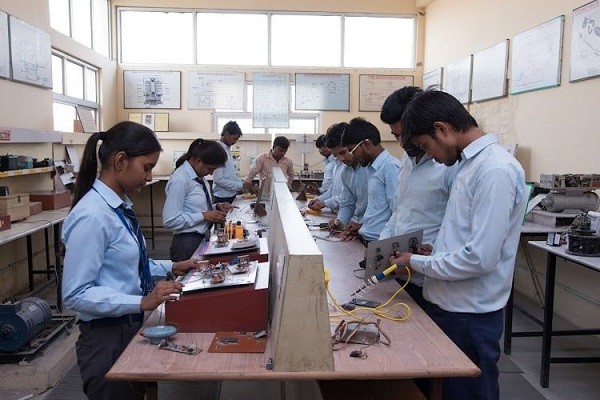 Full moon rising behind a house at night