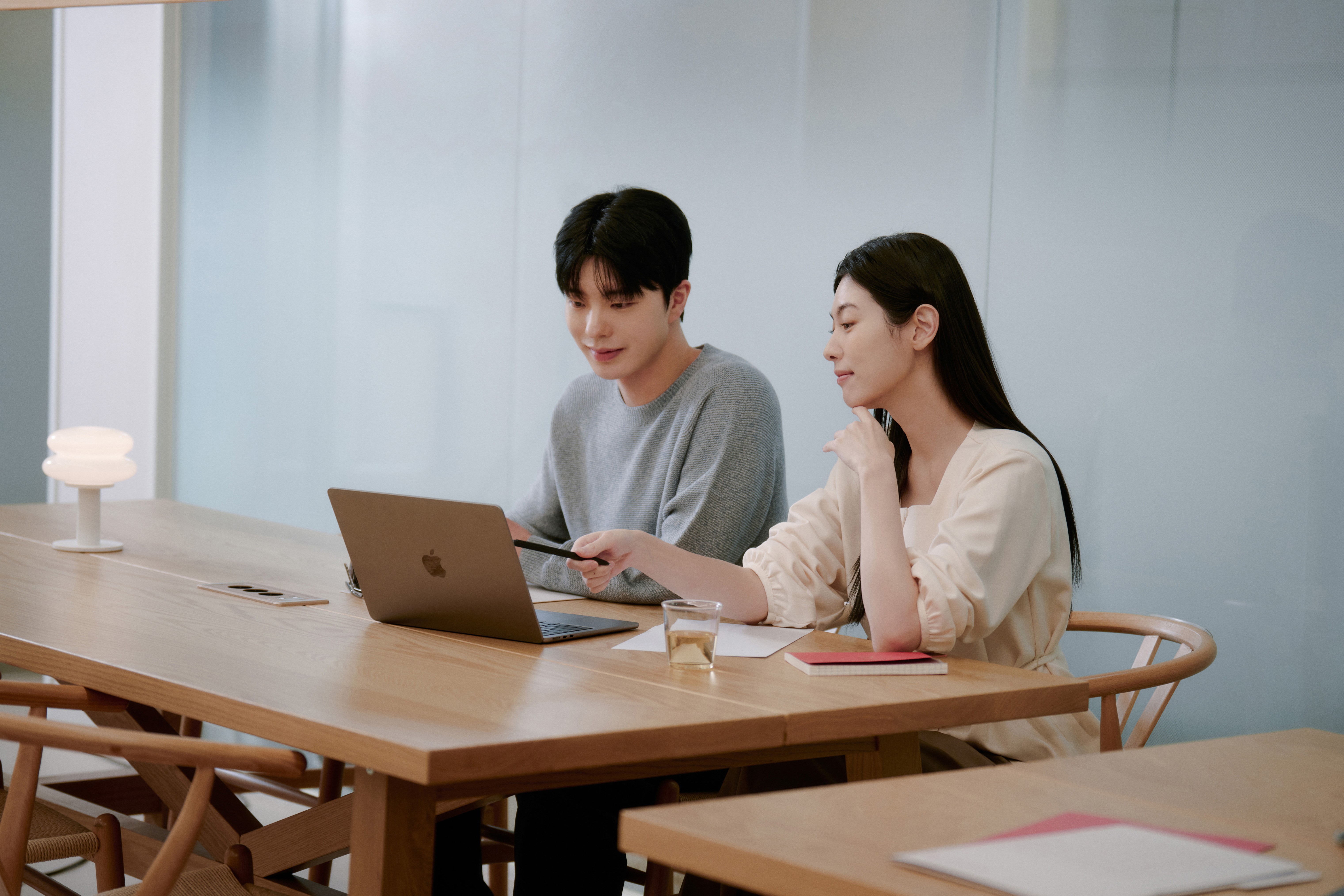 Two students smiling during a language learning session at 612 Academy, reflecting an engaging and human-centered learning experience.