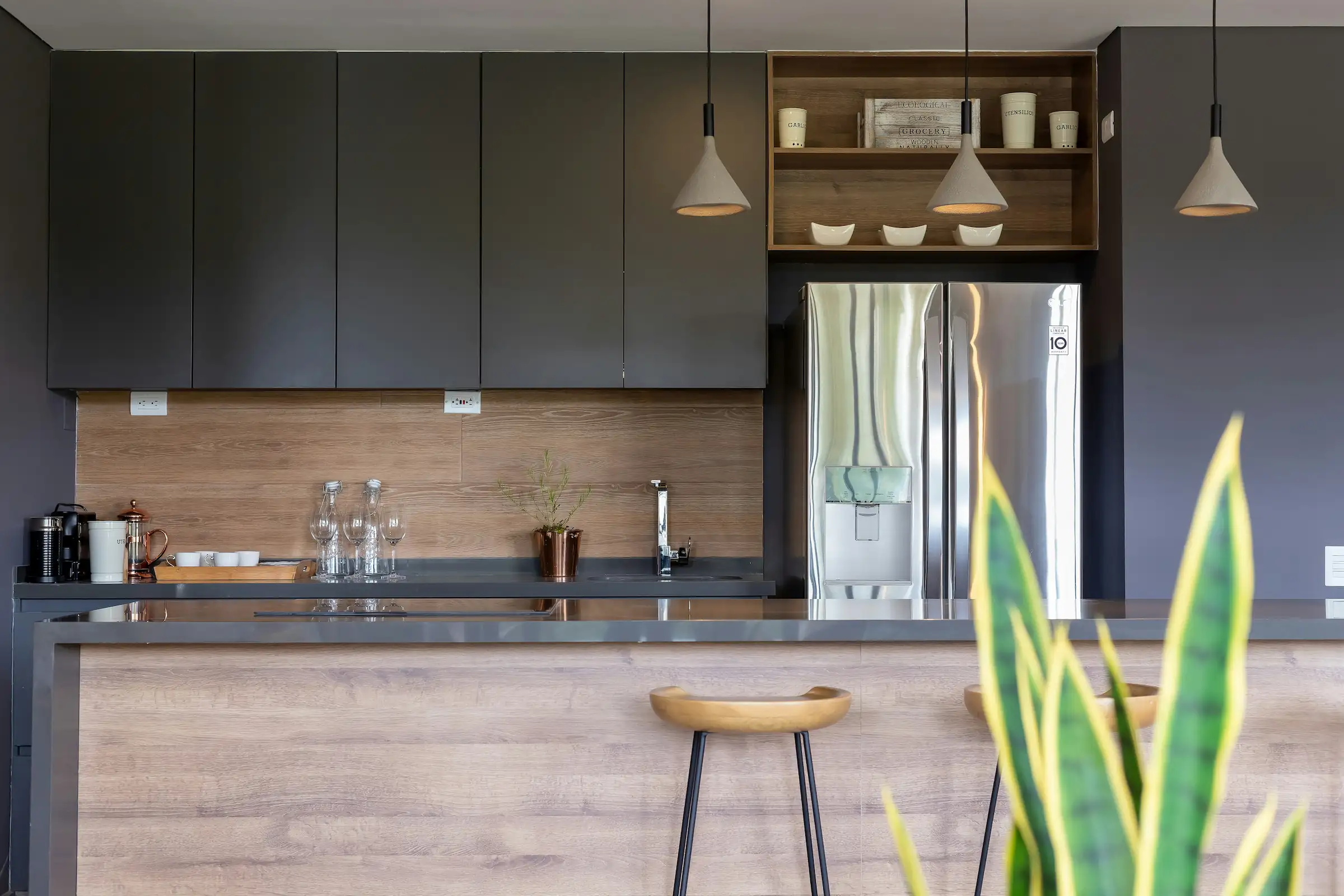 Modern interior entrance with floor-to-ceiling glass walls and warm timber cladding overlooking landscape
