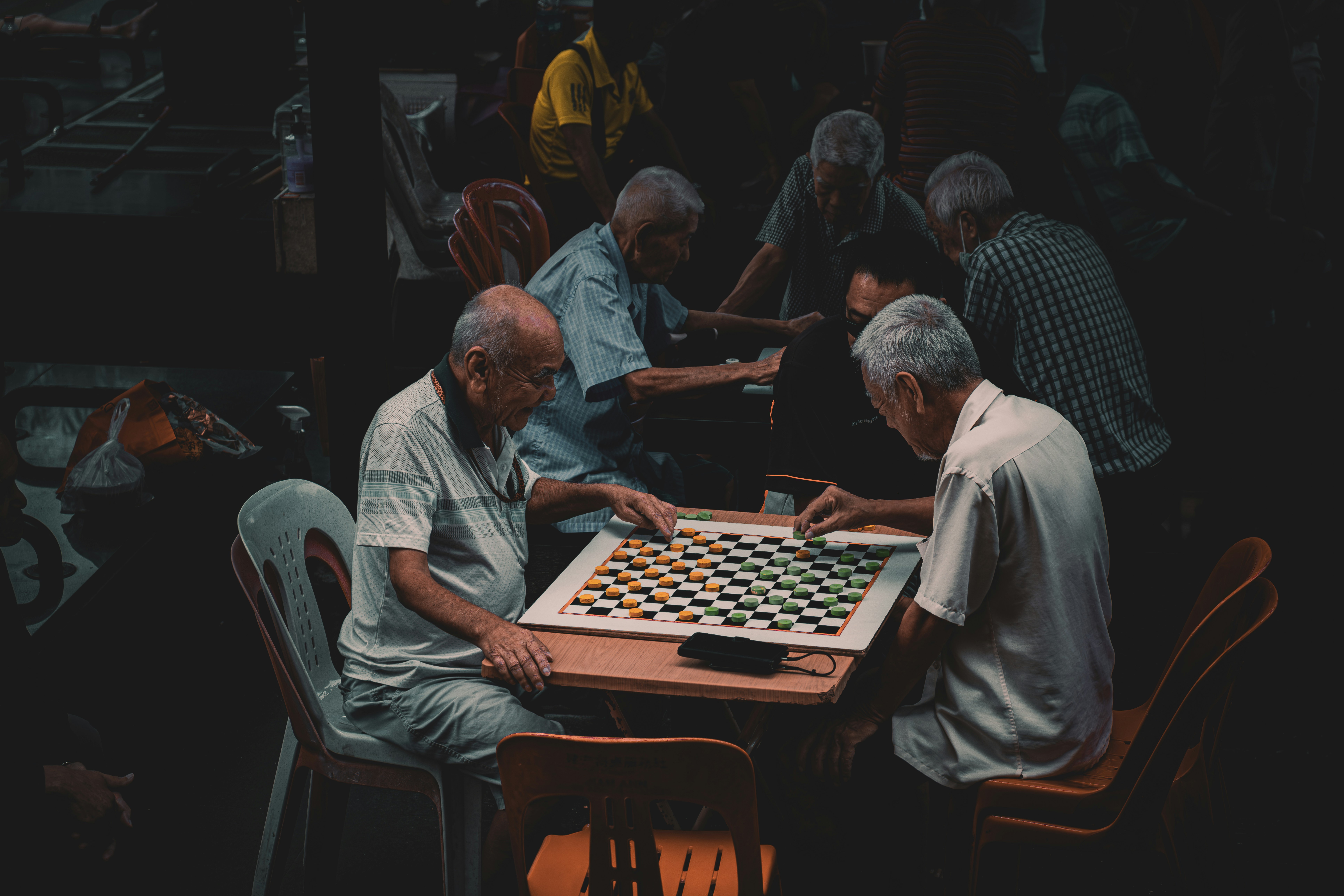 a group of older men playing a game of chess