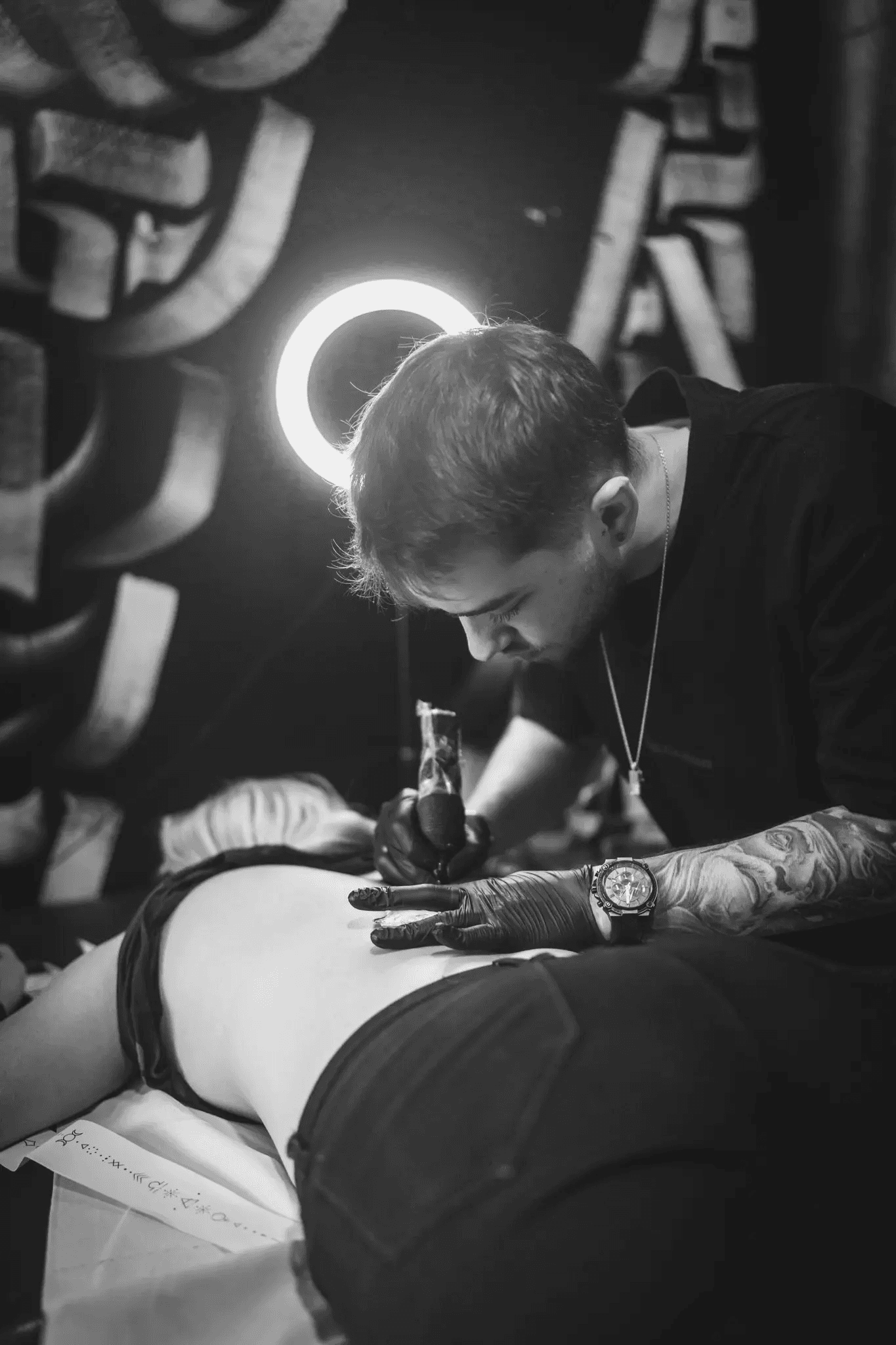 Spacious open-plan office with rows of desks and striking circular ceiling lights.