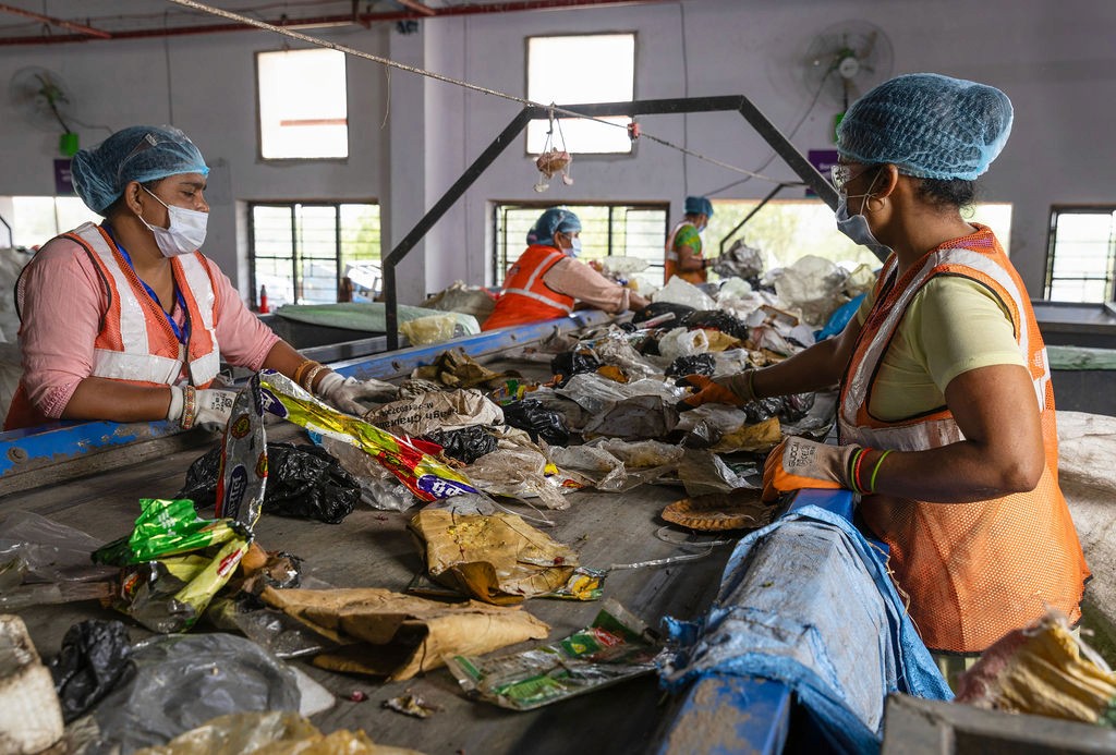 two young boys brushing their teeth in front of a crowd