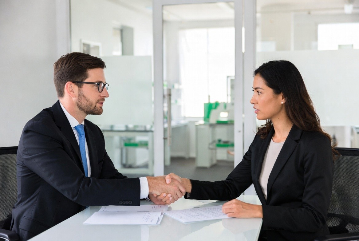 Aerial view of a winding road surrounded by dense green and yellow trees, showcasing nature’s vibrant colors.