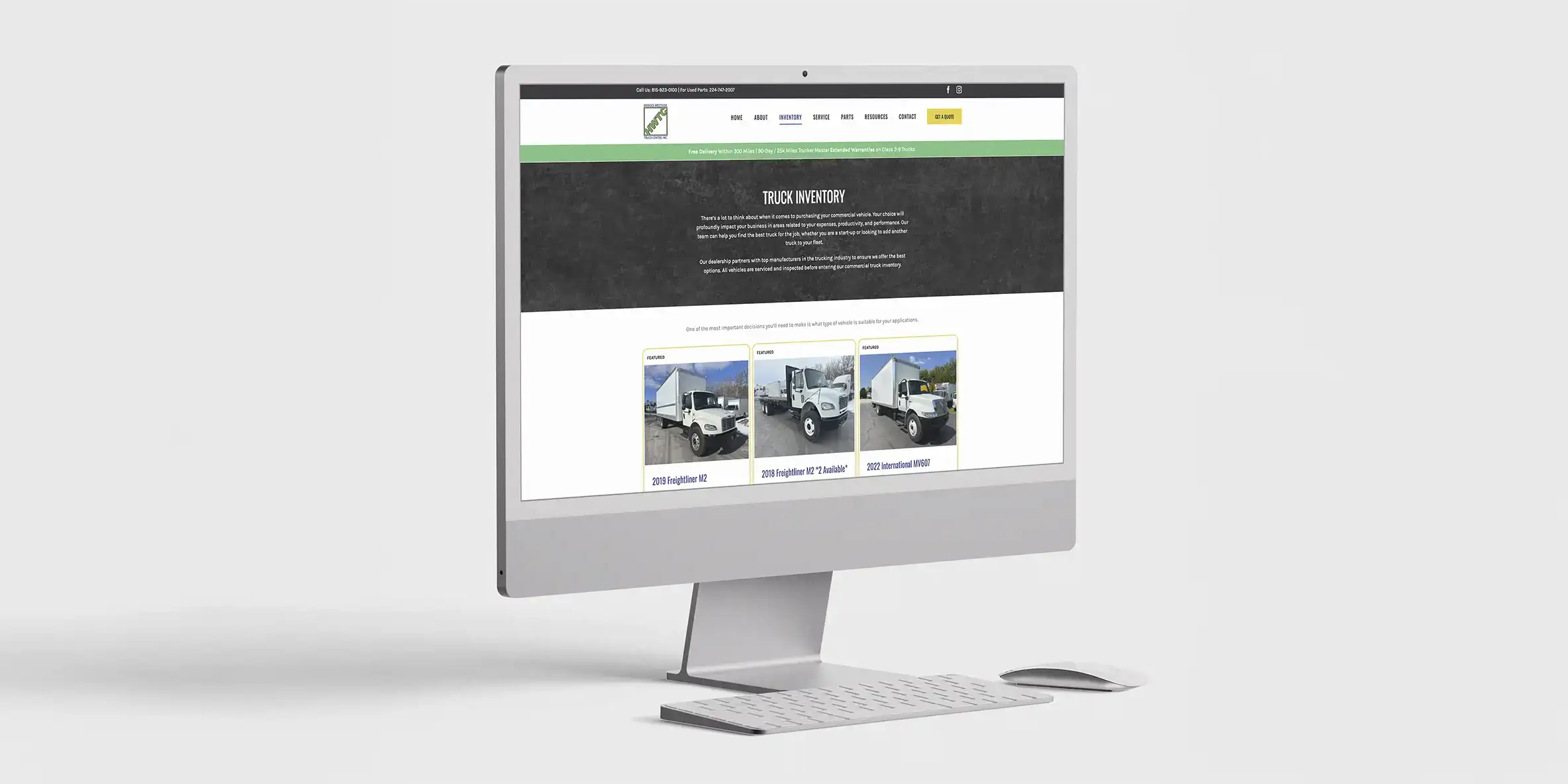 Two focused men in work aprons lean over large blueprints in a dimly lit workshop. A beam of light highlights the papers, creating a dramatic atmosphere.