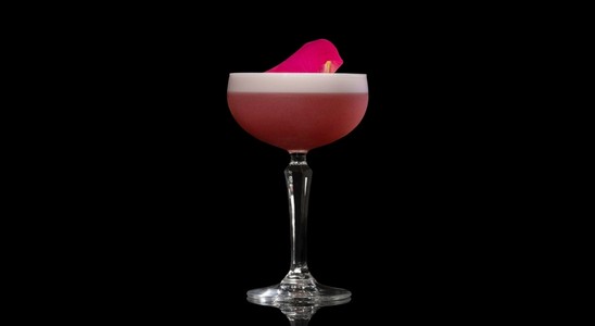A closeup of a Rose Orchard drink against a dark background.