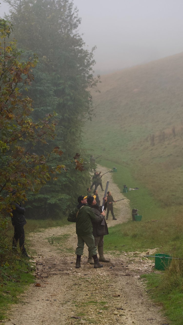 A high-energy shot capturing a group of participants enjoying the thrill of simulated shooting at Raisthorpe Flyers, set against the stunning Yorkshire countryside.