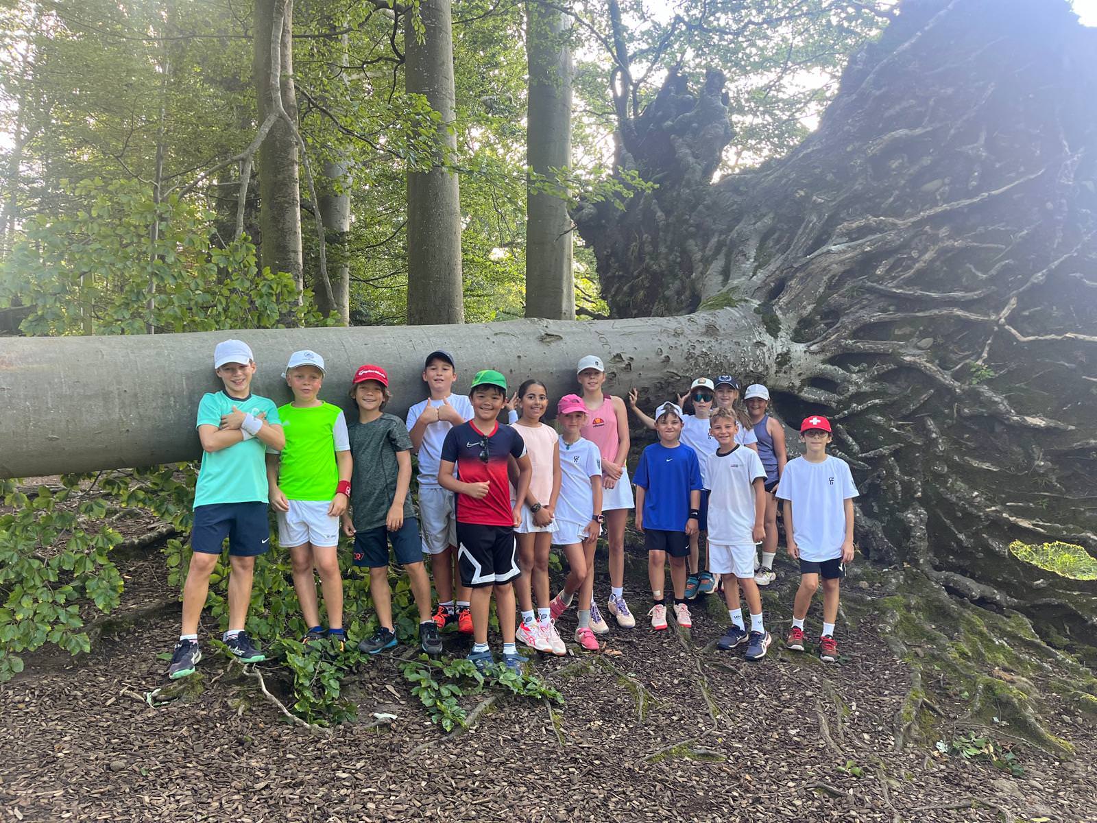 A man stading with Surfboard