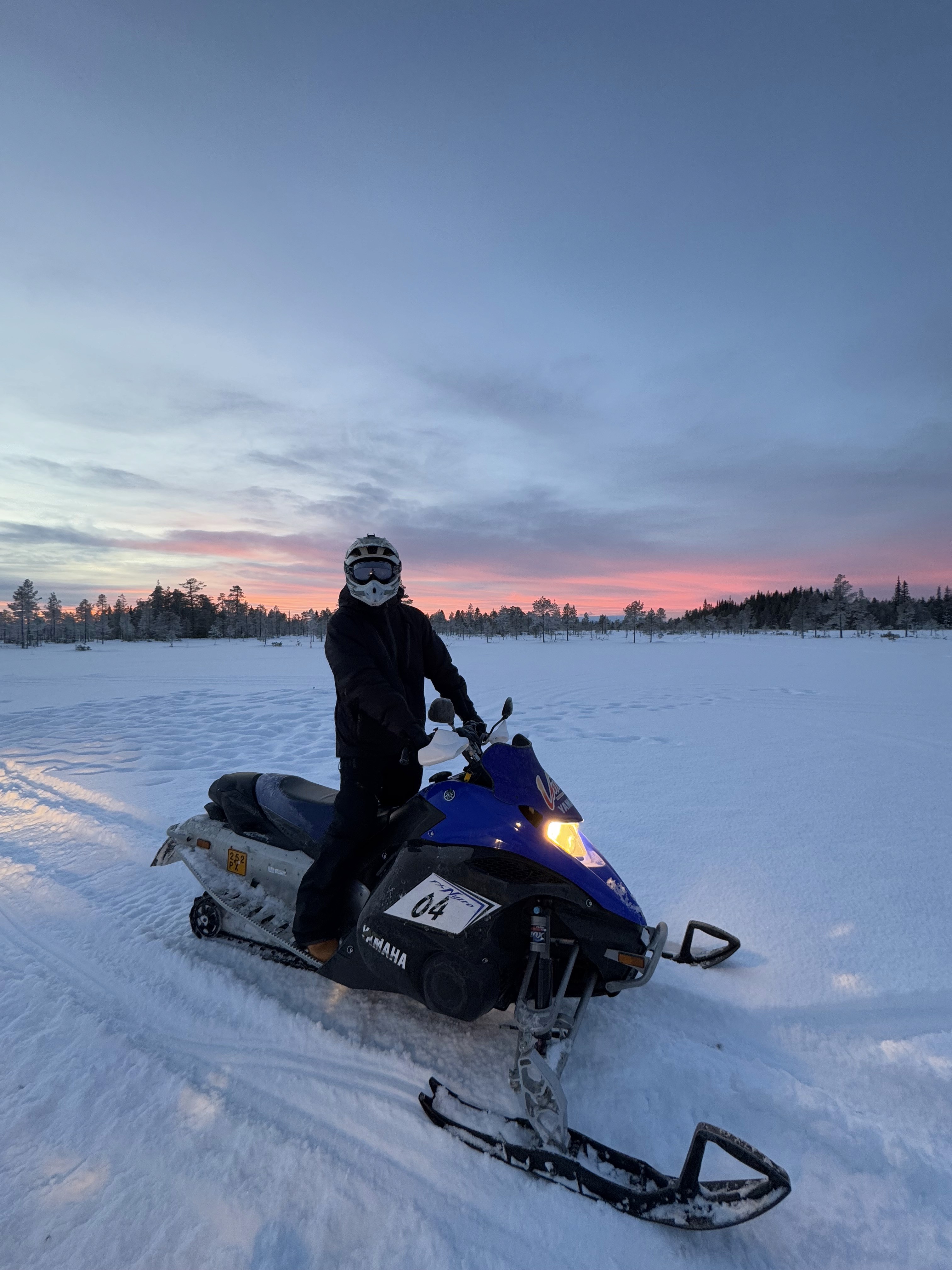 Riding a snowmobile in Lapland Finland